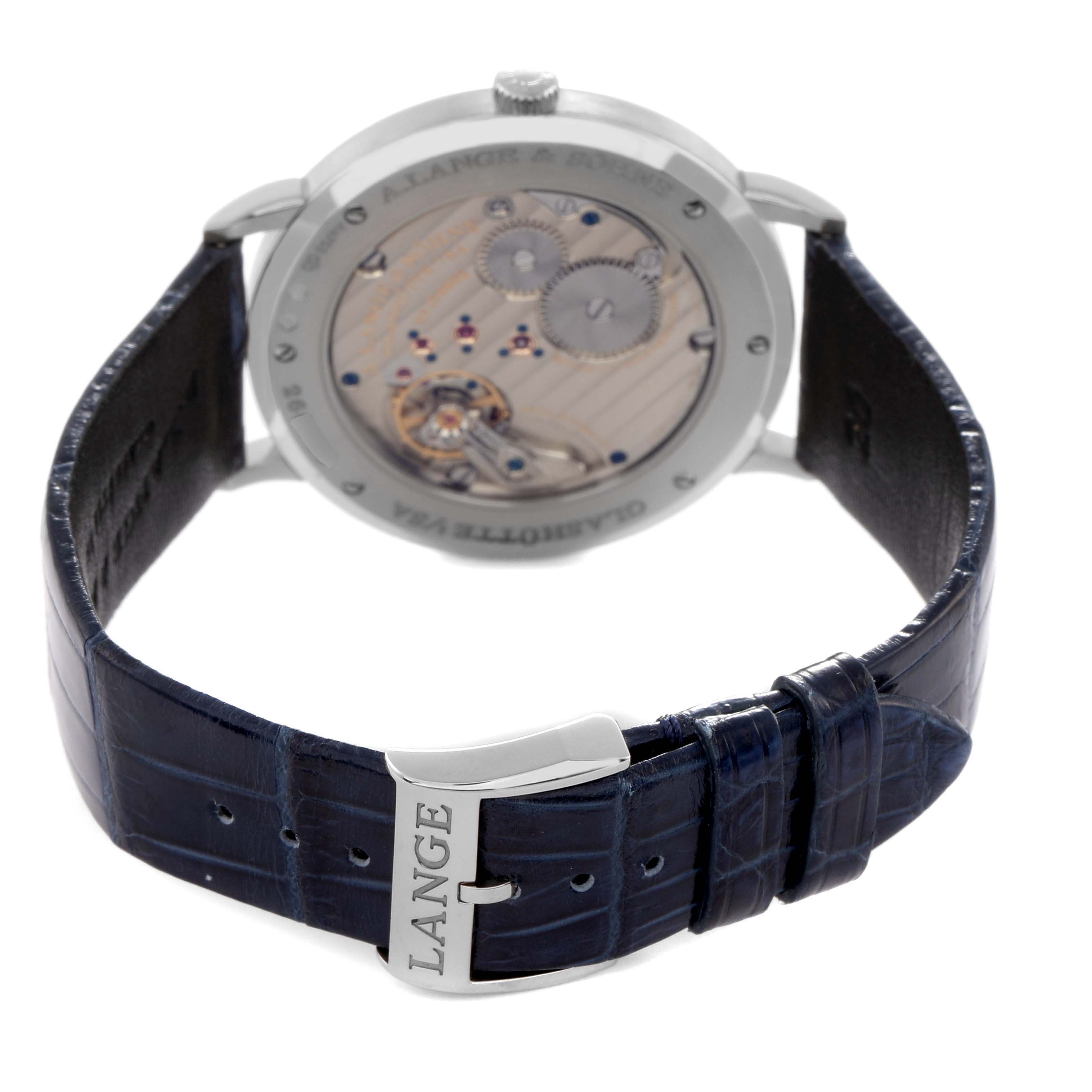 The photo shows the back view of a Saxonia by A. Lange 
Söhne, highlighting the movement and leather strap with a "LANGE" clasp.