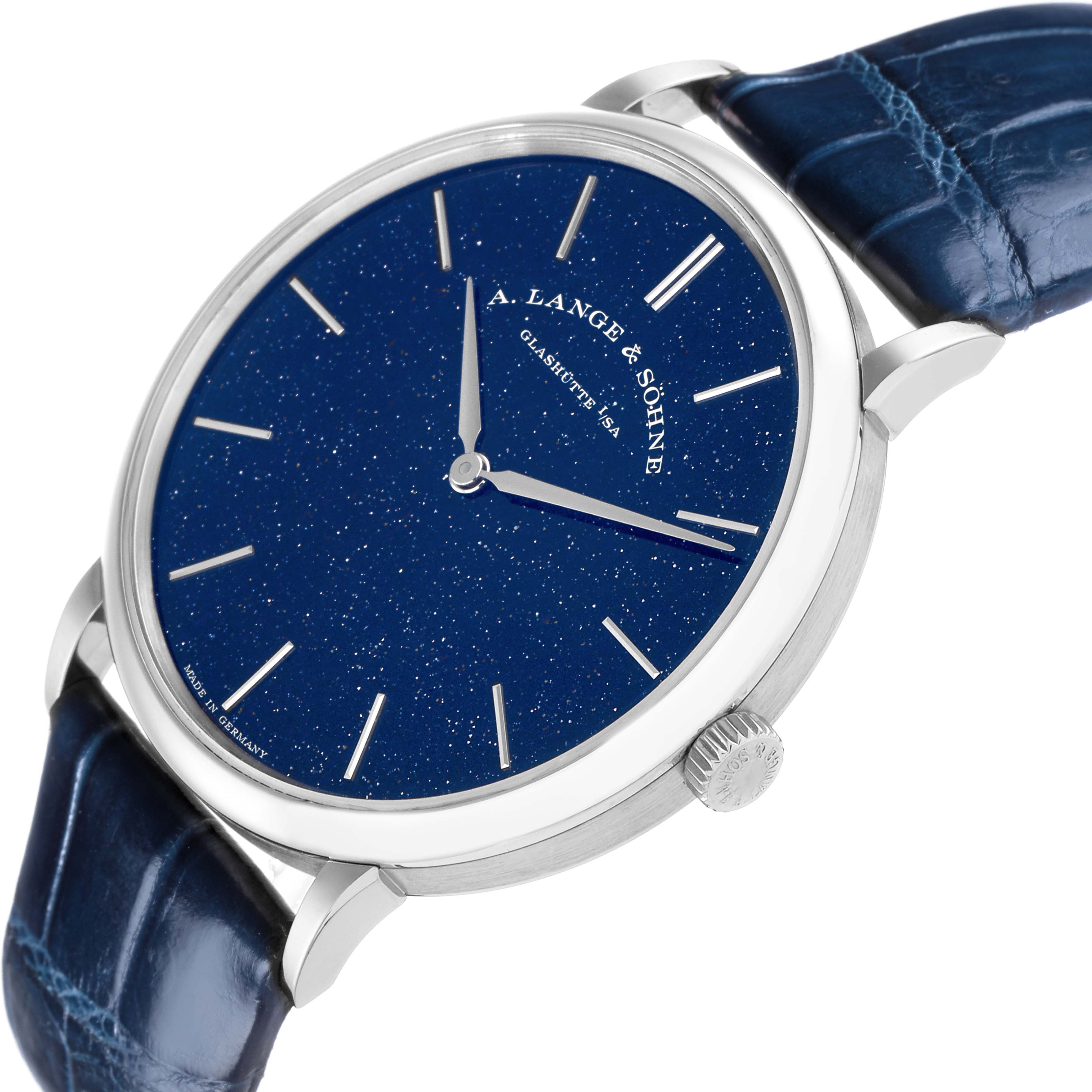 The A. Lange 
Sohne Saxonia 205.086 Men
s White Gold Blue Dial watch is shown from a three-quarter angle, displaying its blue dial, silver hands, crown, and leather strap.