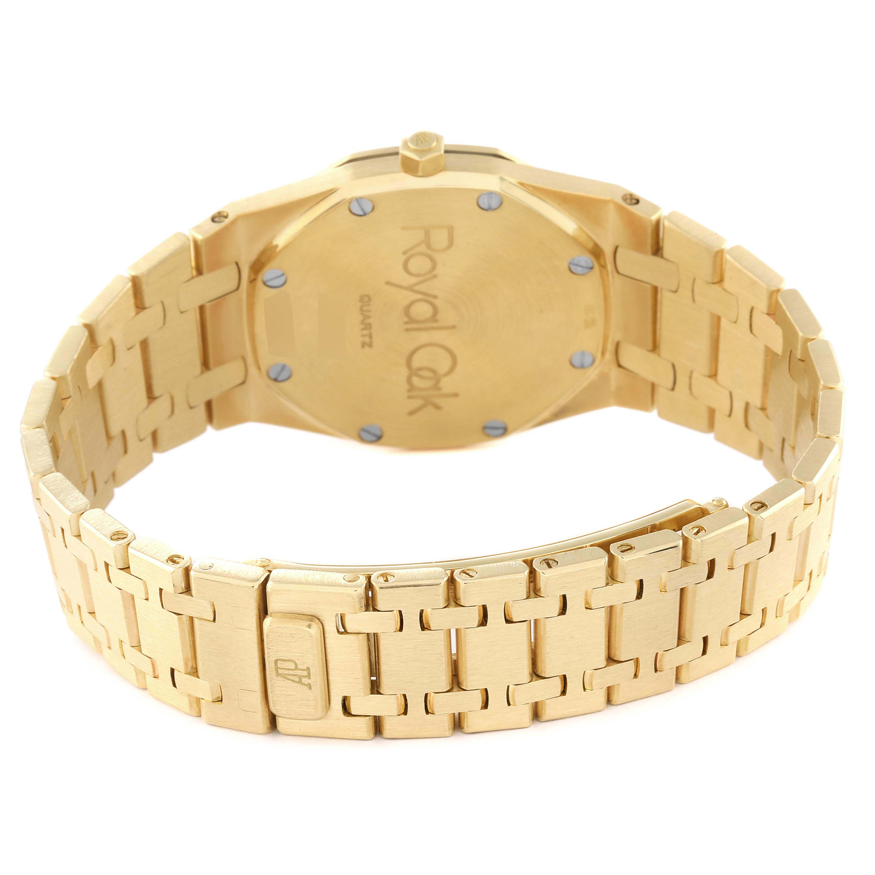 This image shows the back case and bracelet of the Audemars Piguet Royal Oak 56303 Men's Yellow Gold Champagne Dial 56303 Men's Yellow Gold Champagne Dial watch, highlighting the clasp and screw accents.