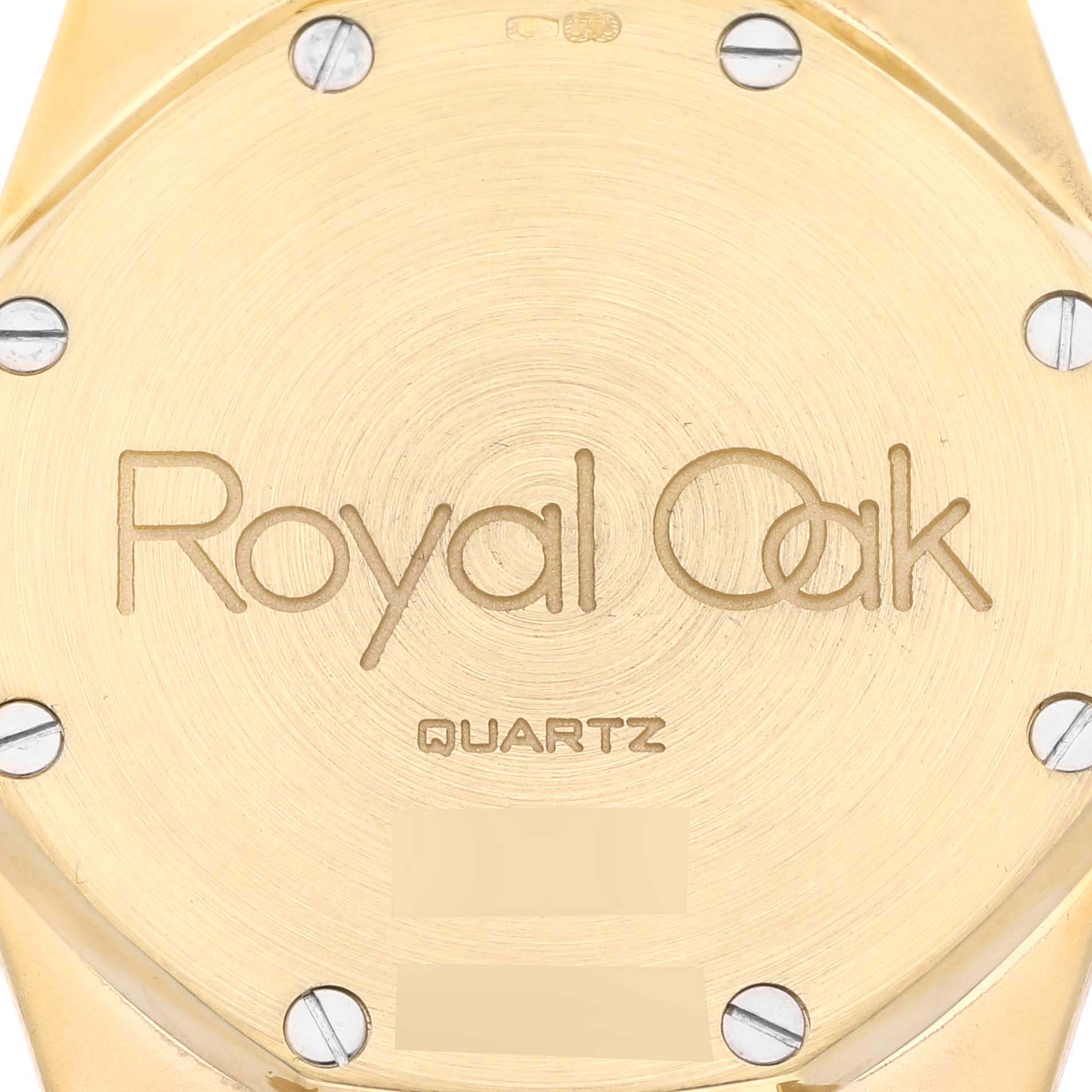The image shows the back case of an Audemars Piguet Royal Oak 56303 Men's Yellow Gold Champagne Dial 56303 Men's Yellow Gold Champagne Dial watch, displaying the logo and Quartz marking.