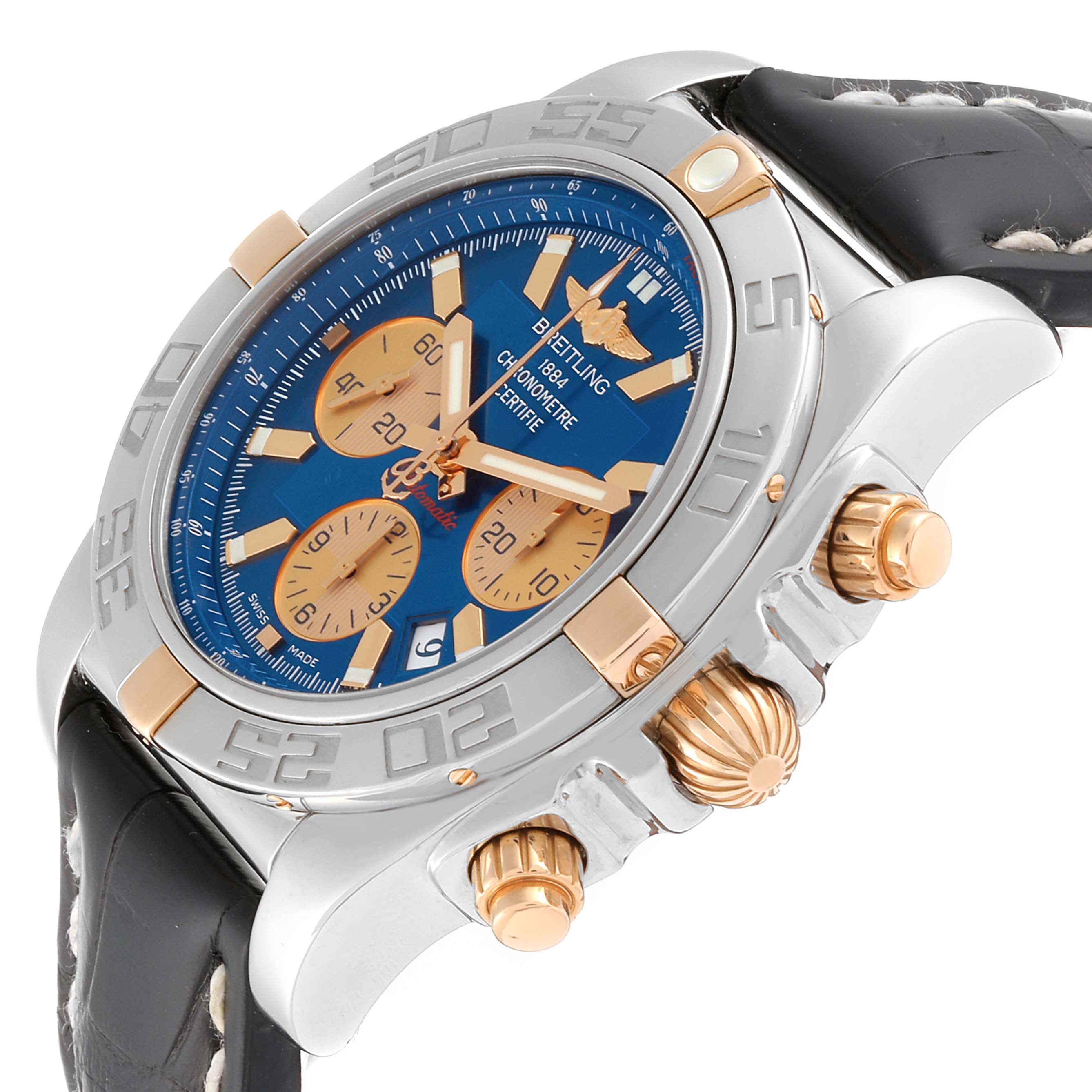 The Breitling Chronomat IB0110 Men's Steel and Gold (two tone) Blue Dial IB0110 Men's Steel and Gold (two tone) Blue Dial watch is shown at an angle highlighting the bezel, crown, pushers, and part of the leather strap.