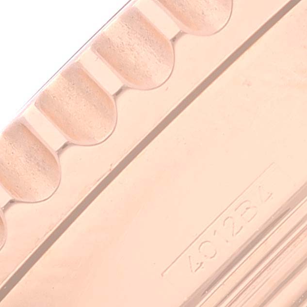 This close-up image shows the side of a bezel or part of the watch case for the Breitling Navitimer RB0120 Men
s Rose Gold Black Dial RB0120 Men
s Rose Gold Black Dial model.