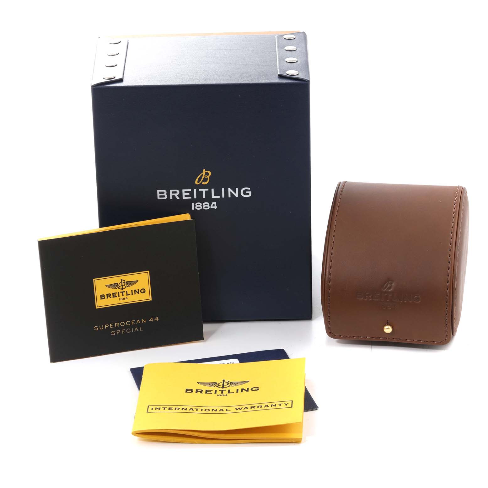 The image shows a Breitling Superocean M17393 Men's Stainless Steel Black Dial M17393 Men's Stainless Steel Black Dial watch box, a brown leather travel case, warranty booklet, and model-specific manual.