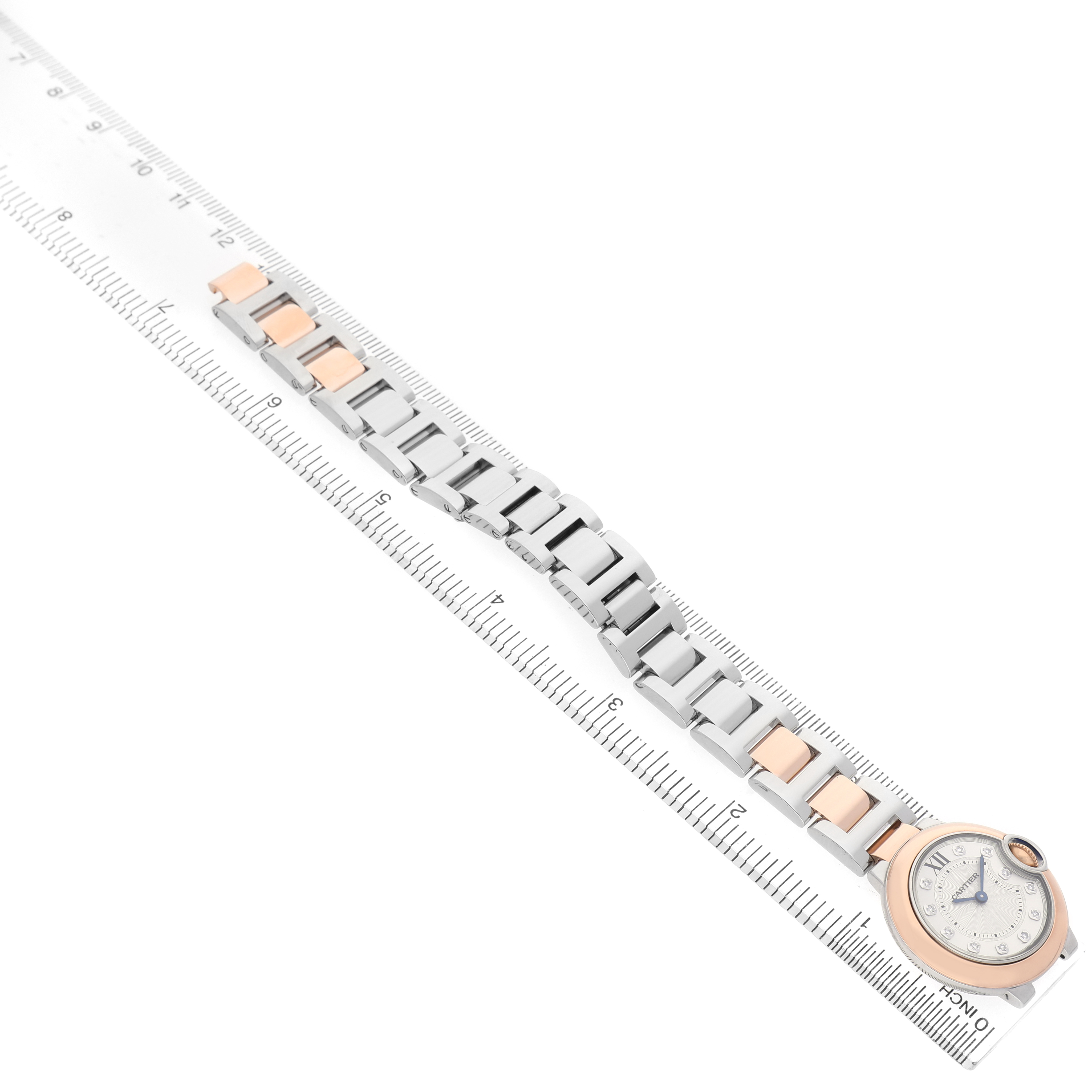 The Cartier Ballon Bleu W3BB0005 Women's Steel and Gold (two tone) Silver Dial watch is shown from a top view, displaying the watch face and metal bracelet alongside a ruler for scale.