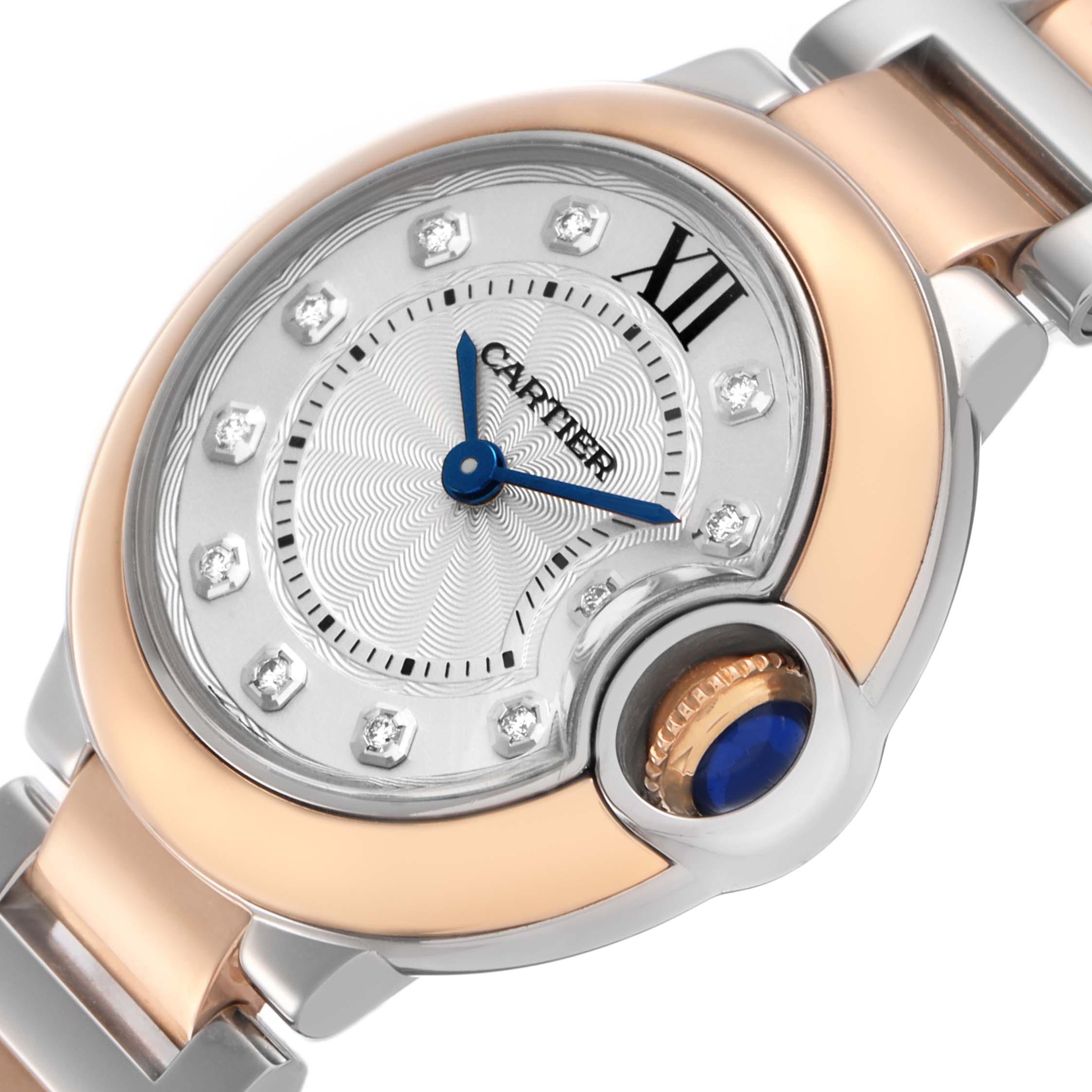 The Cartier Ballon Bleu W3BB0005 Women's Steel and Gold (two tone) Silver Dial watch is shown at a close angle, highlighting the face, blue hands, diamond markers, and cabochon crown.