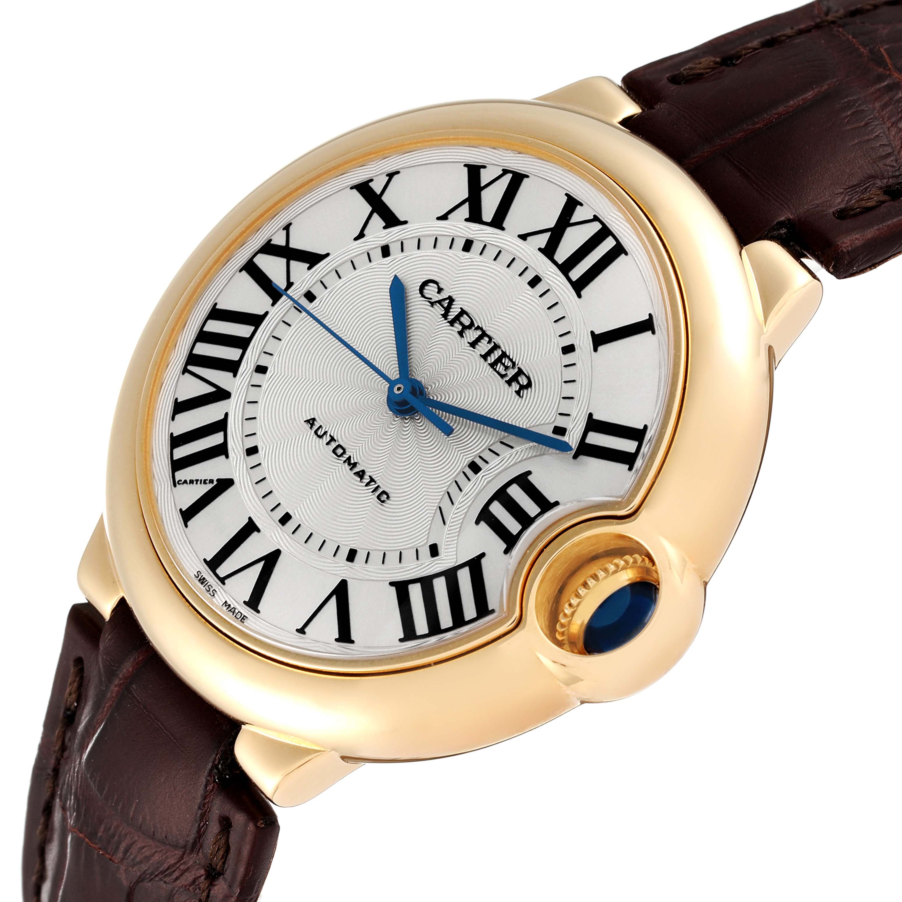 The image shows an angled view of the Cartier Ballon Bleu W6900356 Men's Yellow Gold Silver Dial W6900356 Men's Yellow Gold Silver Dial watch, highlighting its face, crown, and brown leather strap.