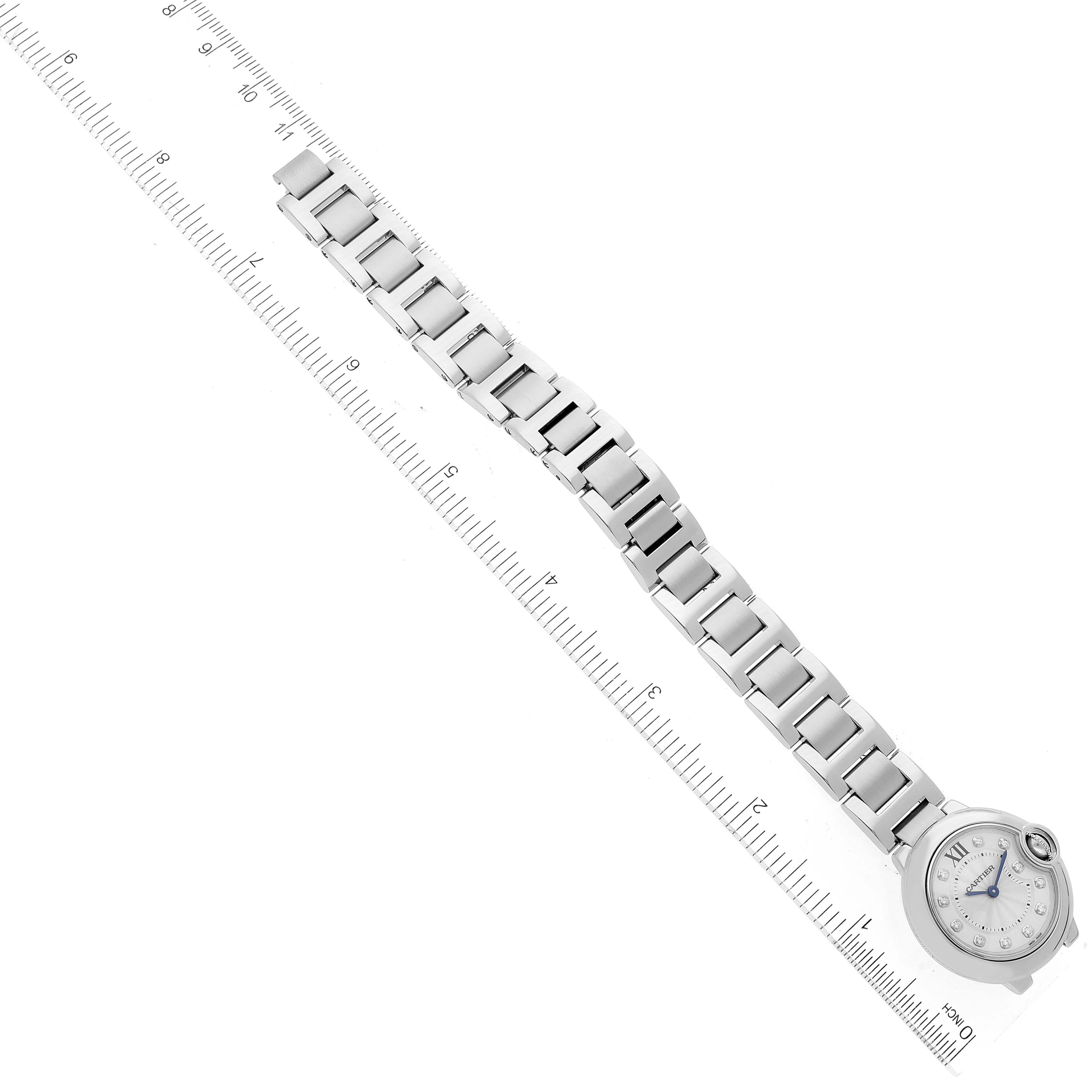 The image shows a top-down view of a Cartier Ballon Bleu WE902073 Women's Stainless Steel Silver Dial WE902073 Women's Stainless Steel Silver Dial watch, displaying its entire bracelet and face aligned with a measuring ruler.