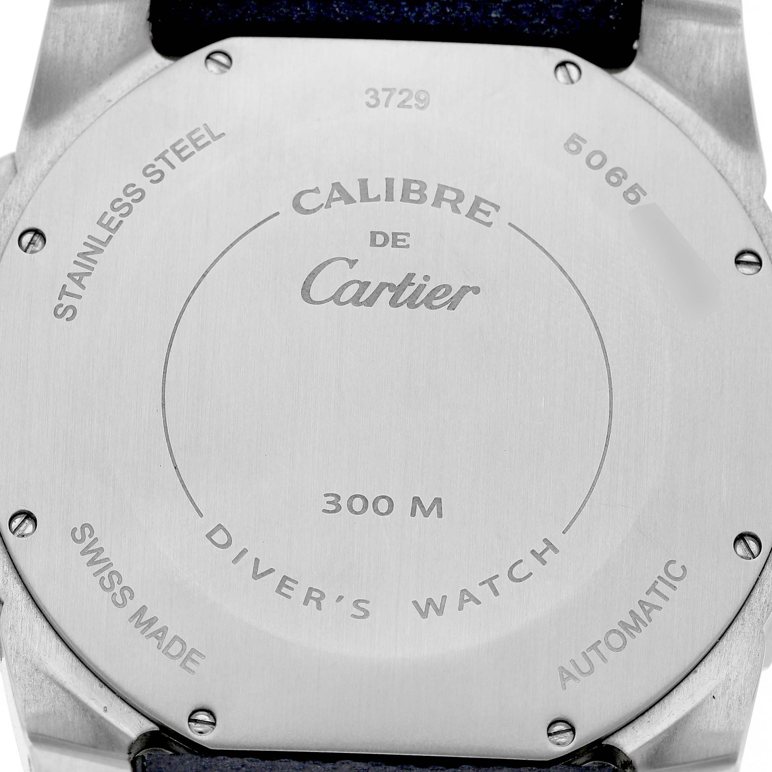 The image shows the back of a Calibre de Cartier watch, highlighting its stainless steel case and water resistance.