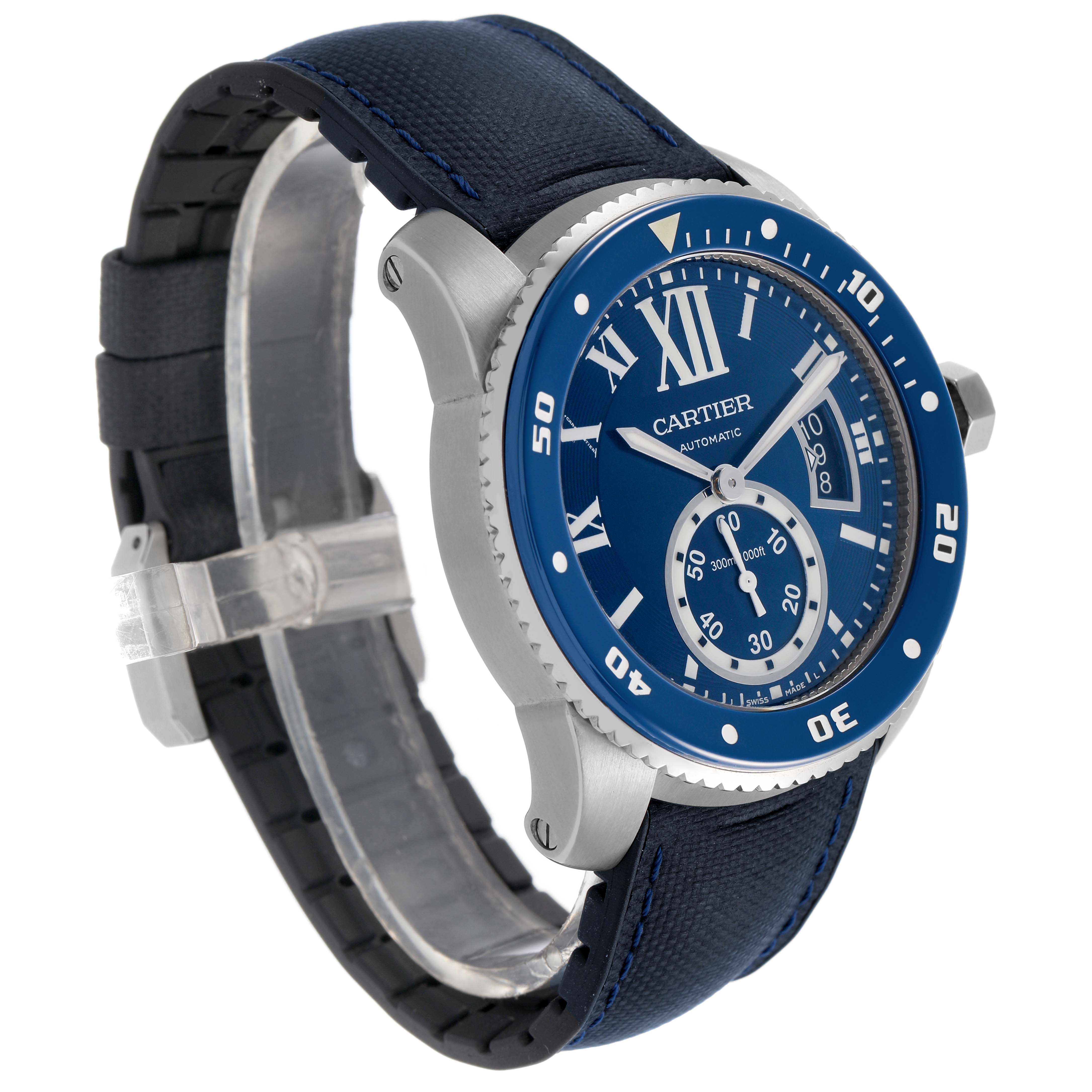 The Calibre de Cartier watch is shown at an angle highlighting the blue dial, bezel, case, strap, and side crown.