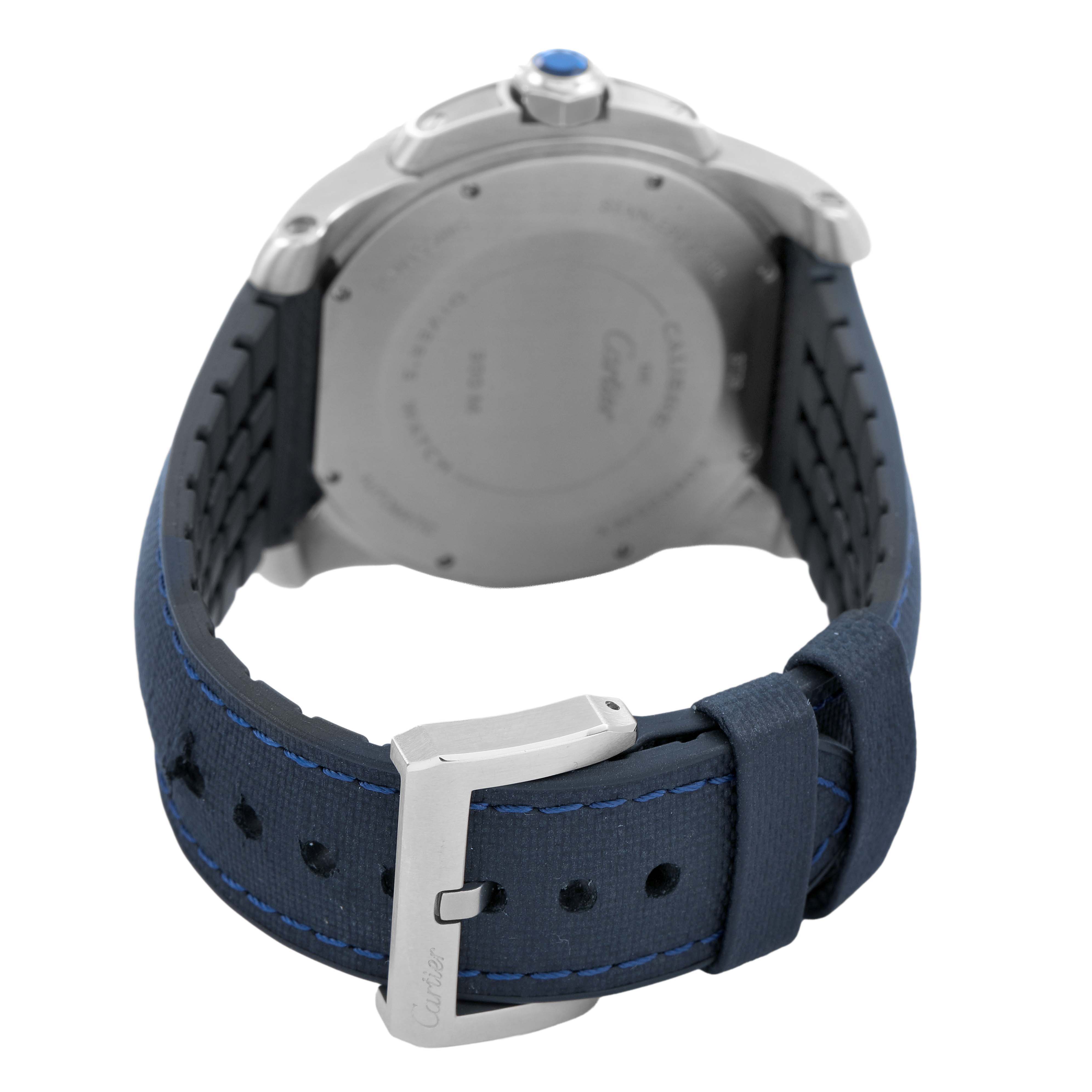 The image shows the back of the Calibre de Cartier watch with a view of the strap and buckle.