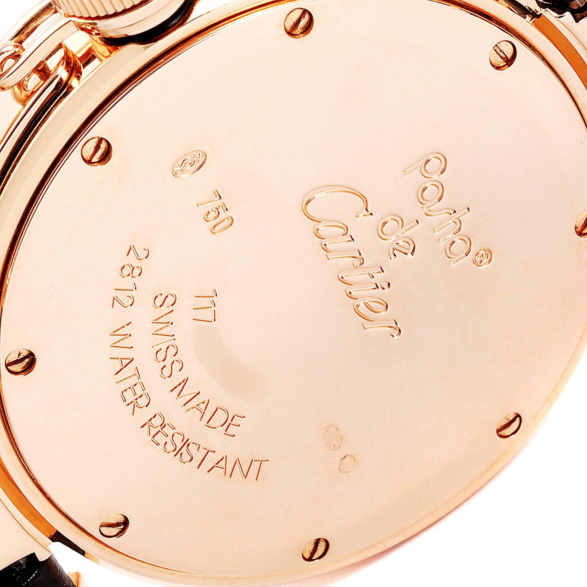The image shows the back case of a Cartier Pasha WJ11913G Women's Rose Gold Silver Dial WJ11913G Women's Rose Gold Silver Dial watch, highlighting its engravings and screws.