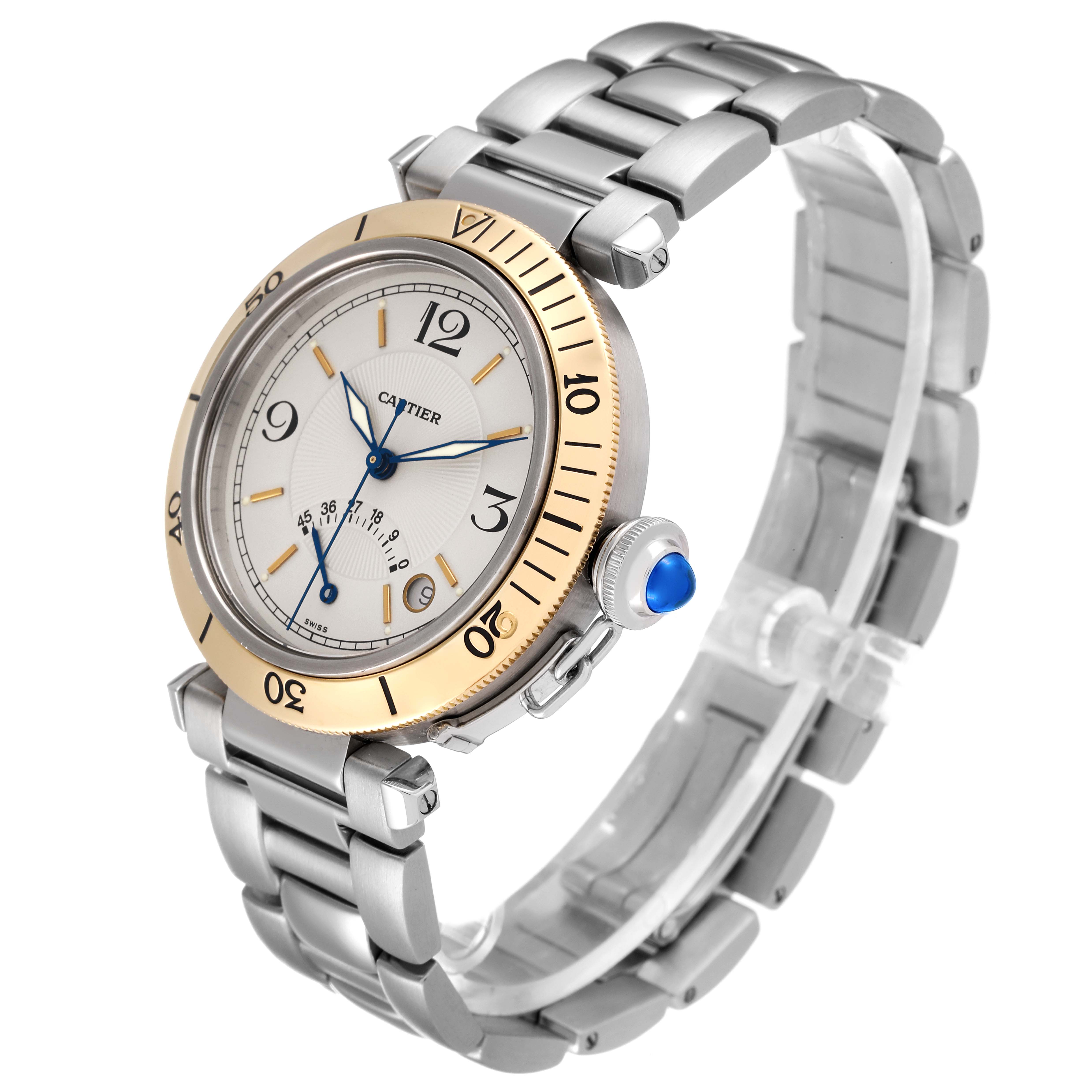 The image shows a Cartier Pasha W31012H3 Men
s Steel and Gold (two tone) Silver Dial W31012H3 Men
s Steel and Gold (two tone) Silver Dial watch at a three-quarter angle, highlighting its face, bracelet, and crown with blue cabochon.