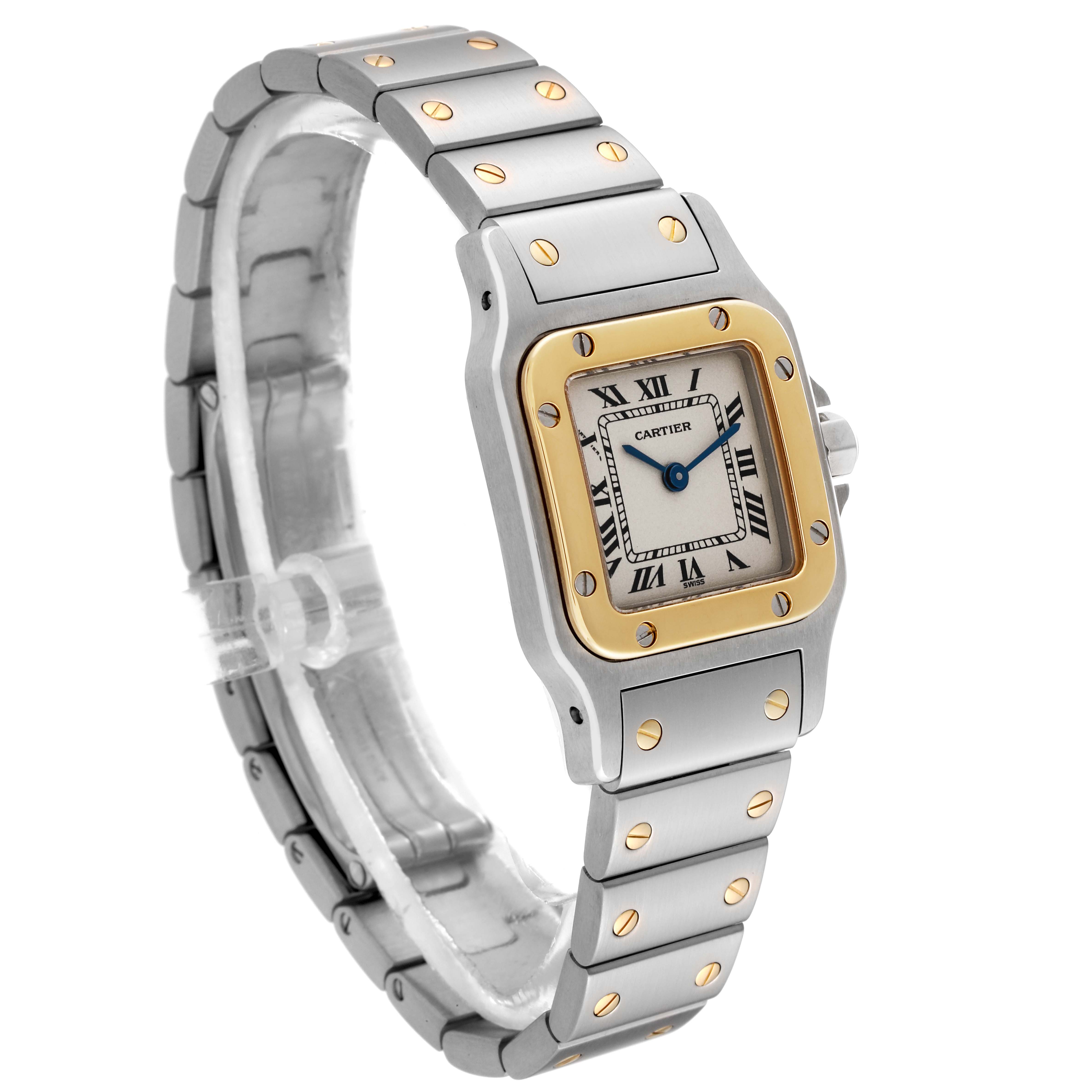 This image shows a Cartier Santos W20012C4 Women's Steel and Gold (two tone) Silver Dial W20012C4 Women's Steel and Gold (two tone) Silver Dial watch at a three-quarter angle showcasing the face, bezel, and bracelet.