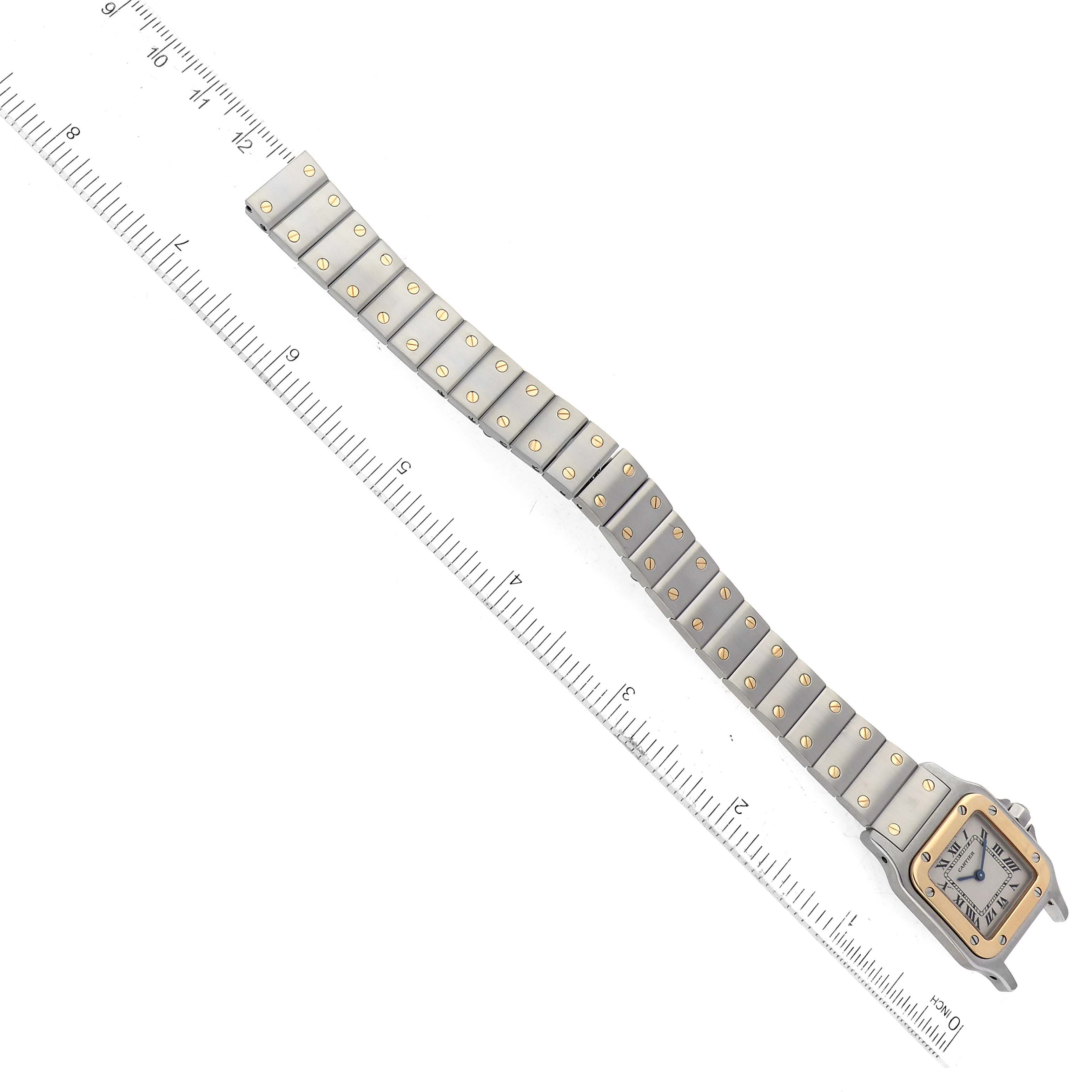 The Santos model by Cartier is shown from the top view, displaying the full bracelet and face alongside a measurement ruler.