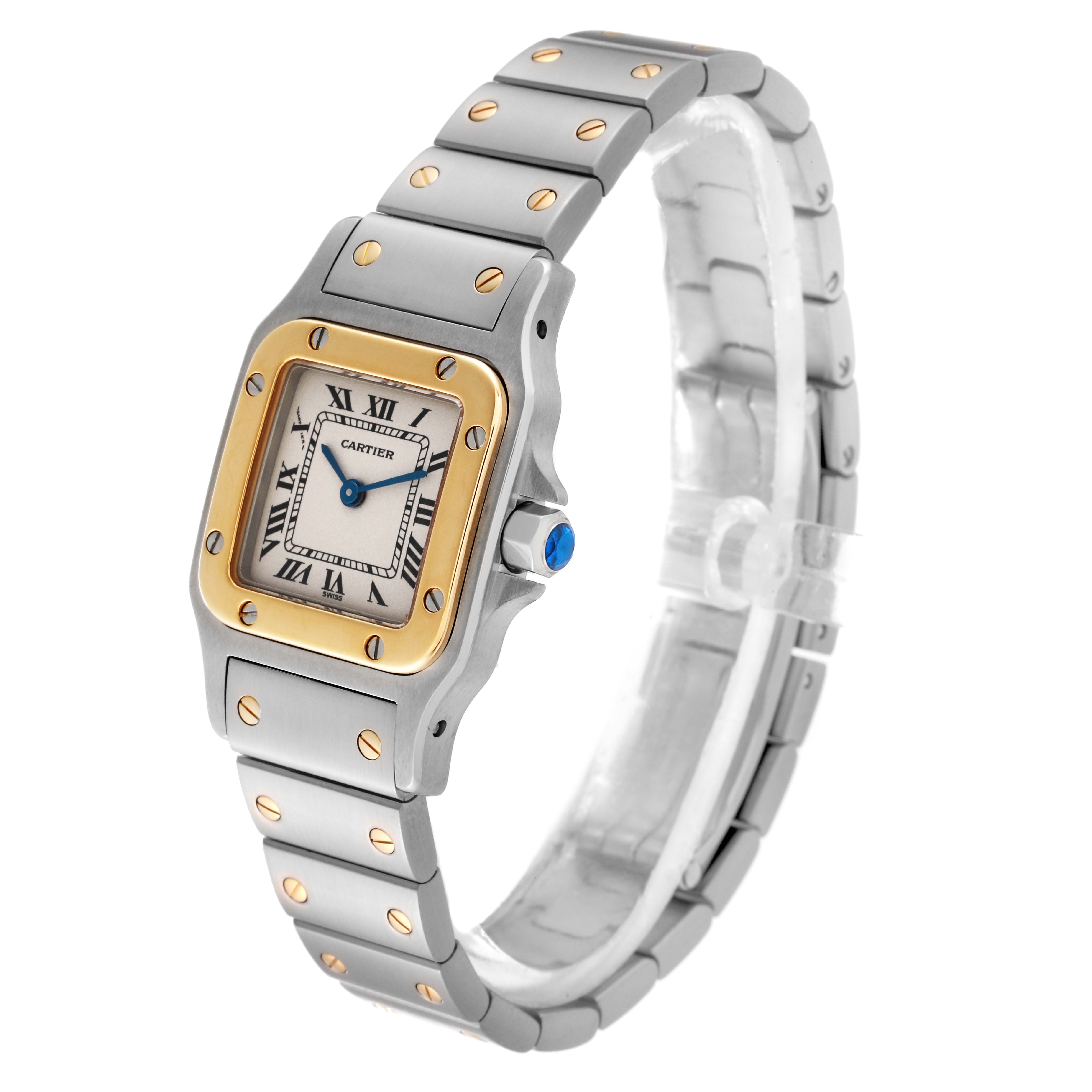This is a side angle view showing the face, bezel, crown, and bracelet of the Cartier Santos W20012C4 Women's Steel and Gold (two tone) Silver Dial W20012C4 Women's Steel and Gold (two tone) Silver Dial watch.