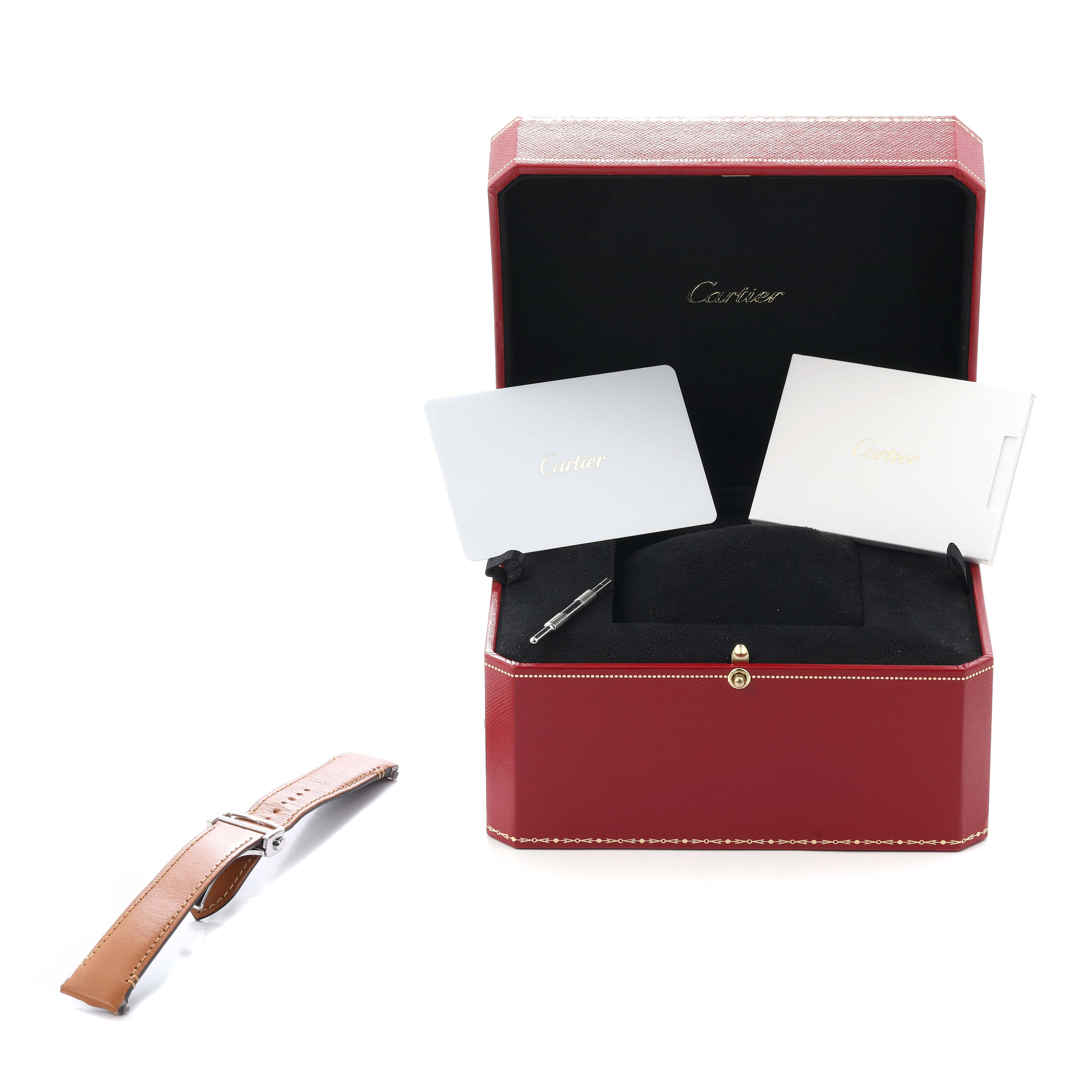 The Cartier Santos WSSA0029 Men
s Stainless Steel Silver Dial set includes a leather strap, cards, a tool, and a red case, shown from the top angle.