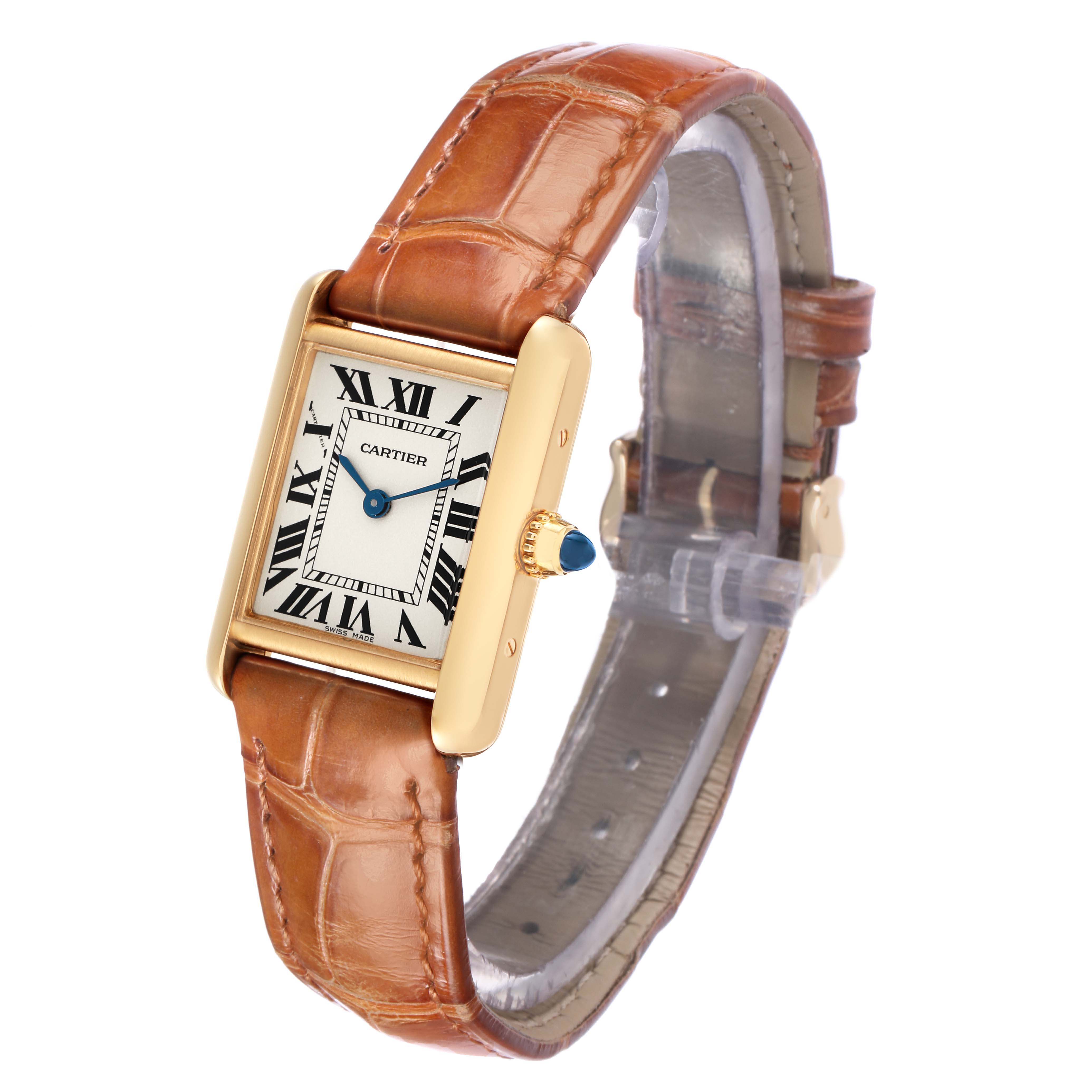 The Cartier Tank Louis W1529856 Women
s Yellow Gold Silver Dial watch is shown at an angled front view, highlighting the face, gold case, and brown leather strap.