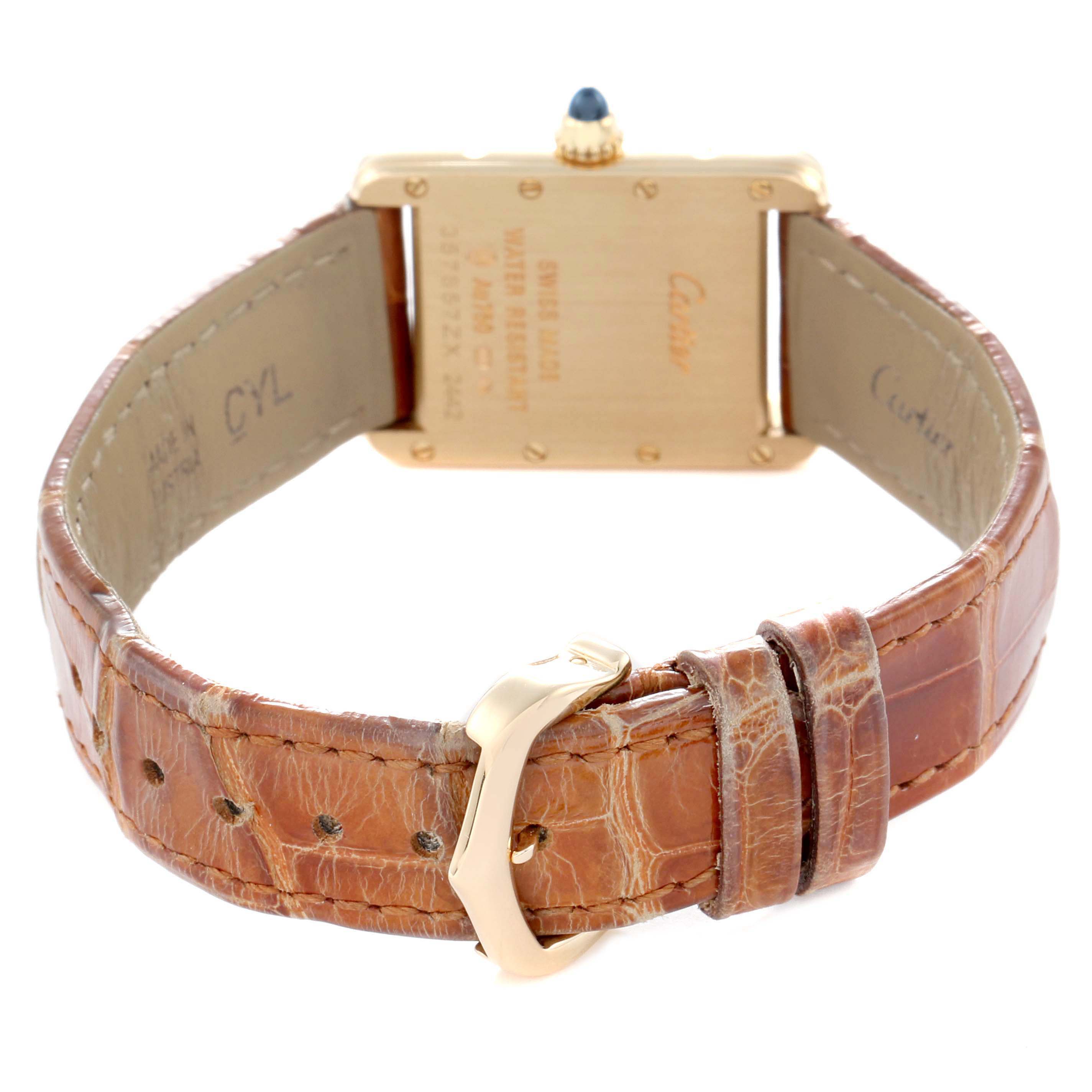 The image shows the back of the Cartier Tank Louis W1529856 Women
s Yellow Gold Silver Dial watch with a focus on the leather strap and buckle.