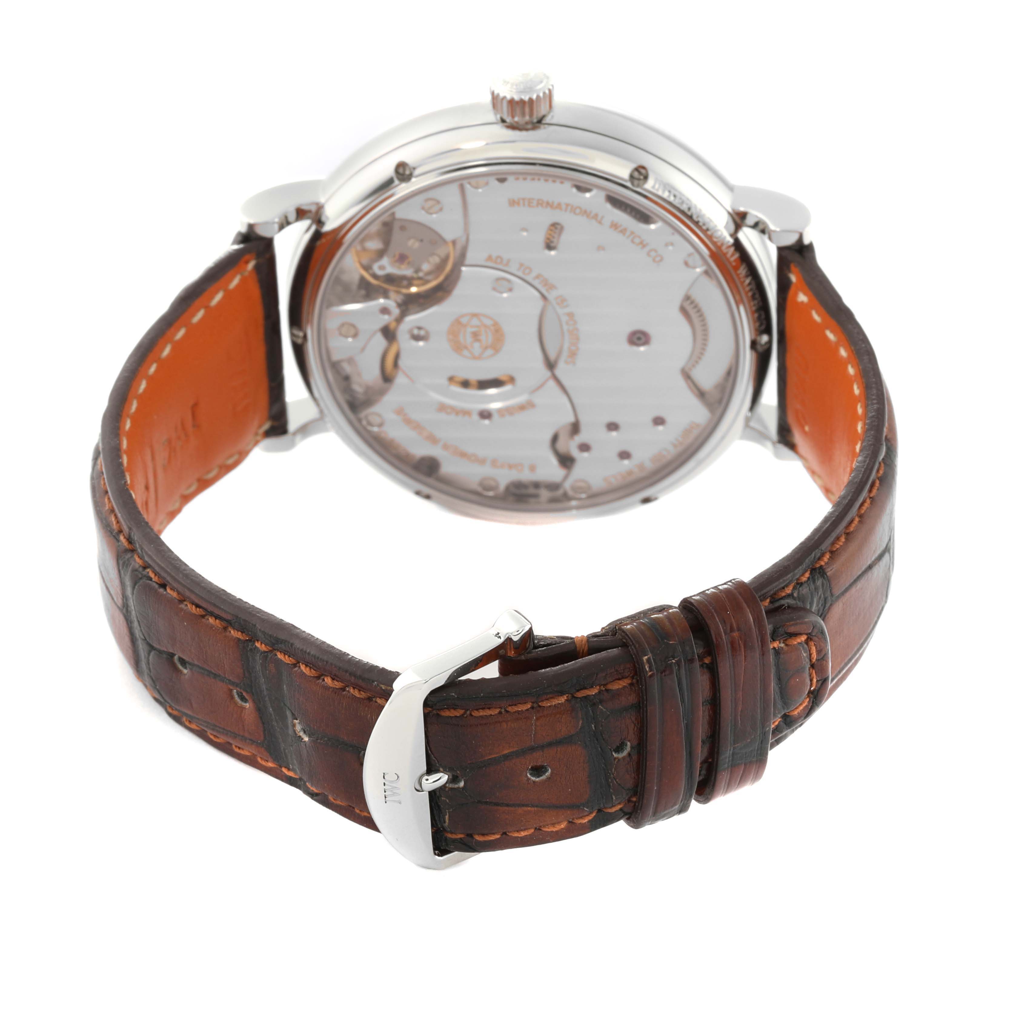 The IWC Portofino IW510103 Men
s Stainless Steel Silver Dial watch is shown from the rear, displaying the transparent case back and brown leather strap.