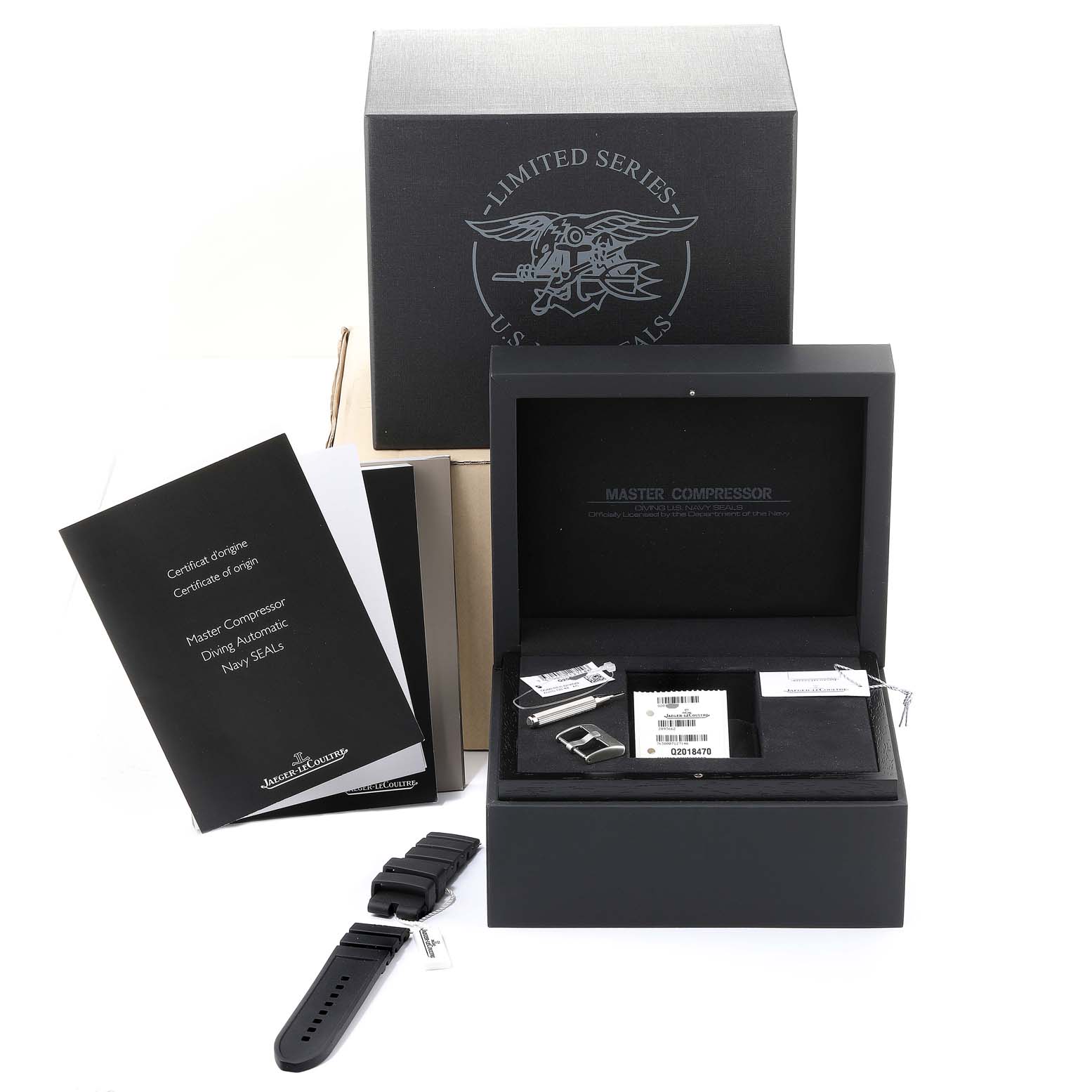 The image shows the Jaeger LeCoultre Master Q2018770 Men's Stainless Steel Black Dial Q2018770 Men's Stainless Steel Black Dial Compressor watch box, manuals, extra strap, and accessories from a top-down angle.