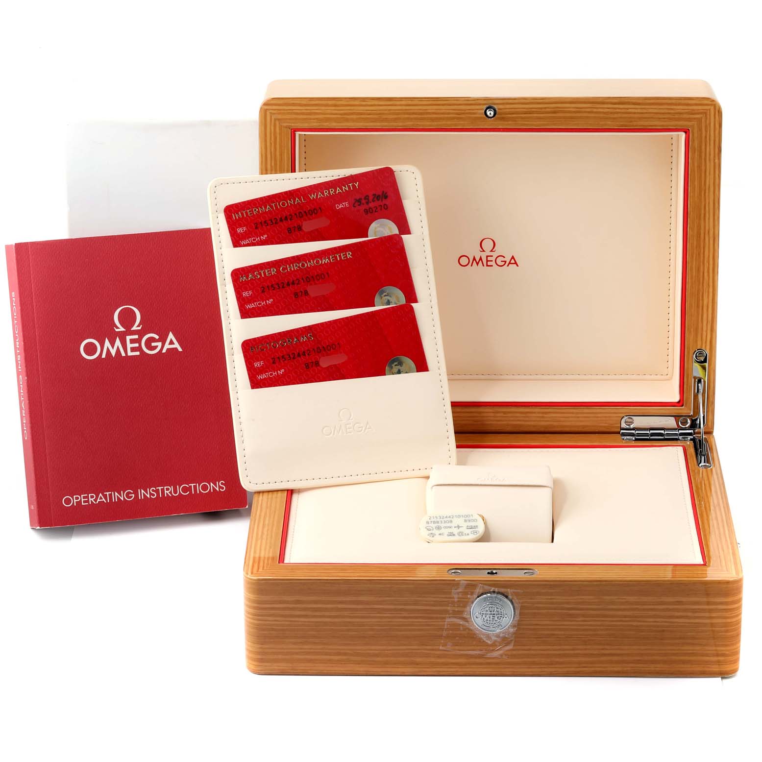 The image shows the packaging and accessories of an Omega Planet Ocean 215.32.44.21.01.003 Men
s Stainless Steel Black Dial 215.32.44.21.01.003 Men
s Stainless Steel Black Dial watch, including a wooden box, warranty cards, and an instruction manual.