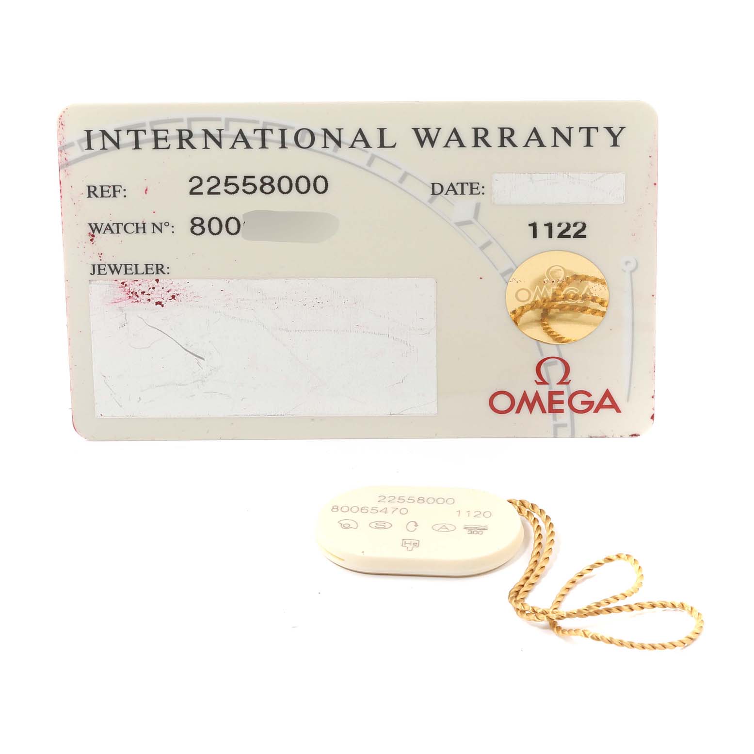 The image shows the international warranty card and a tag for the Seamaster model by Omega, viewed from the front.