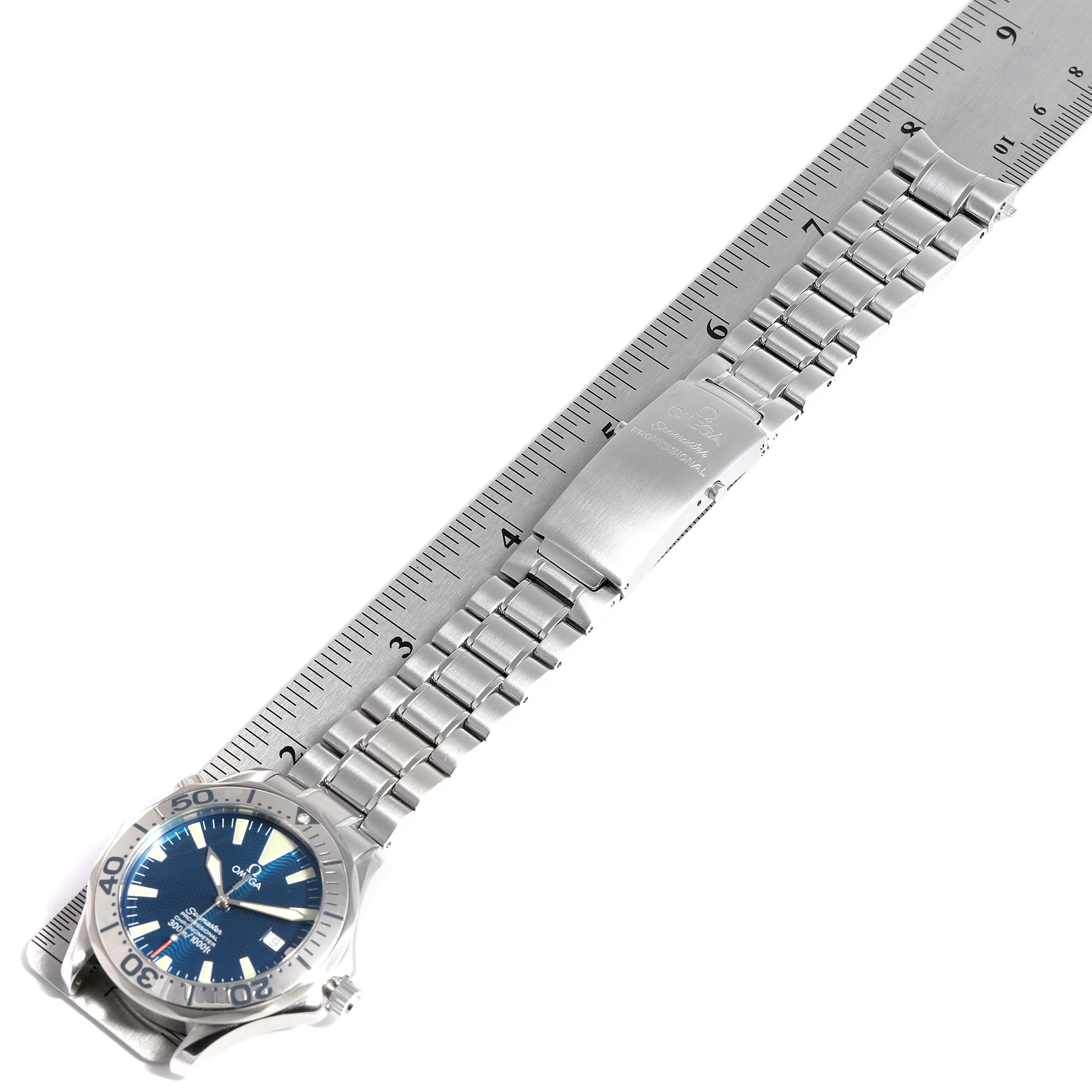 The image displays an Omega Seamaster 2255.80.00 Men
s Stainless Steel Blue Dial 2255.80.00 Men
s Stainless Steel Blue Dial watch lying flat with its stainless steel bracelet and clasp extended alongside a ruler.