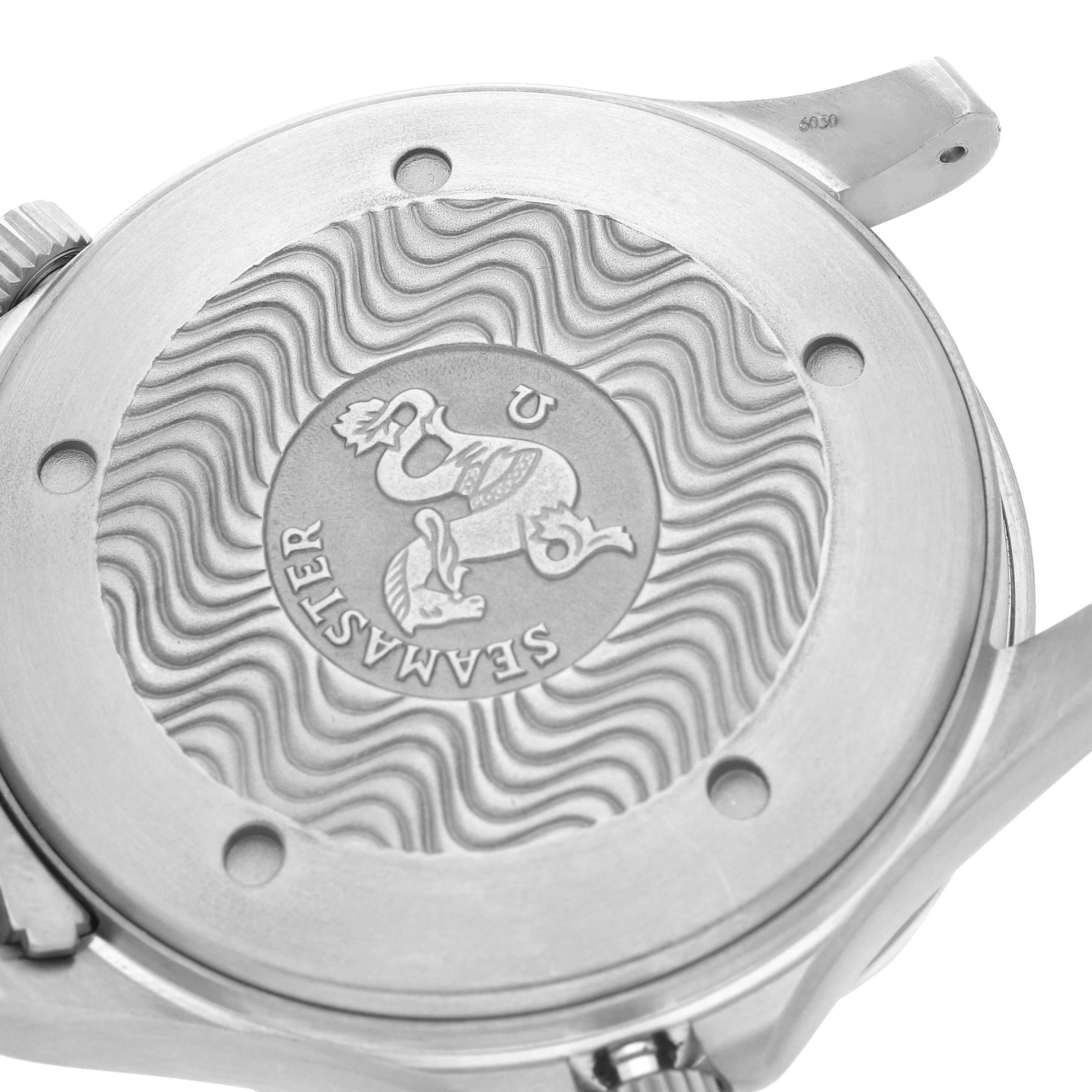 The image shows the back of an Omega Seamaster 2231.80.00 Men
s Titanium Blue Dial watch, featuring the engraved logo and wave pattern.