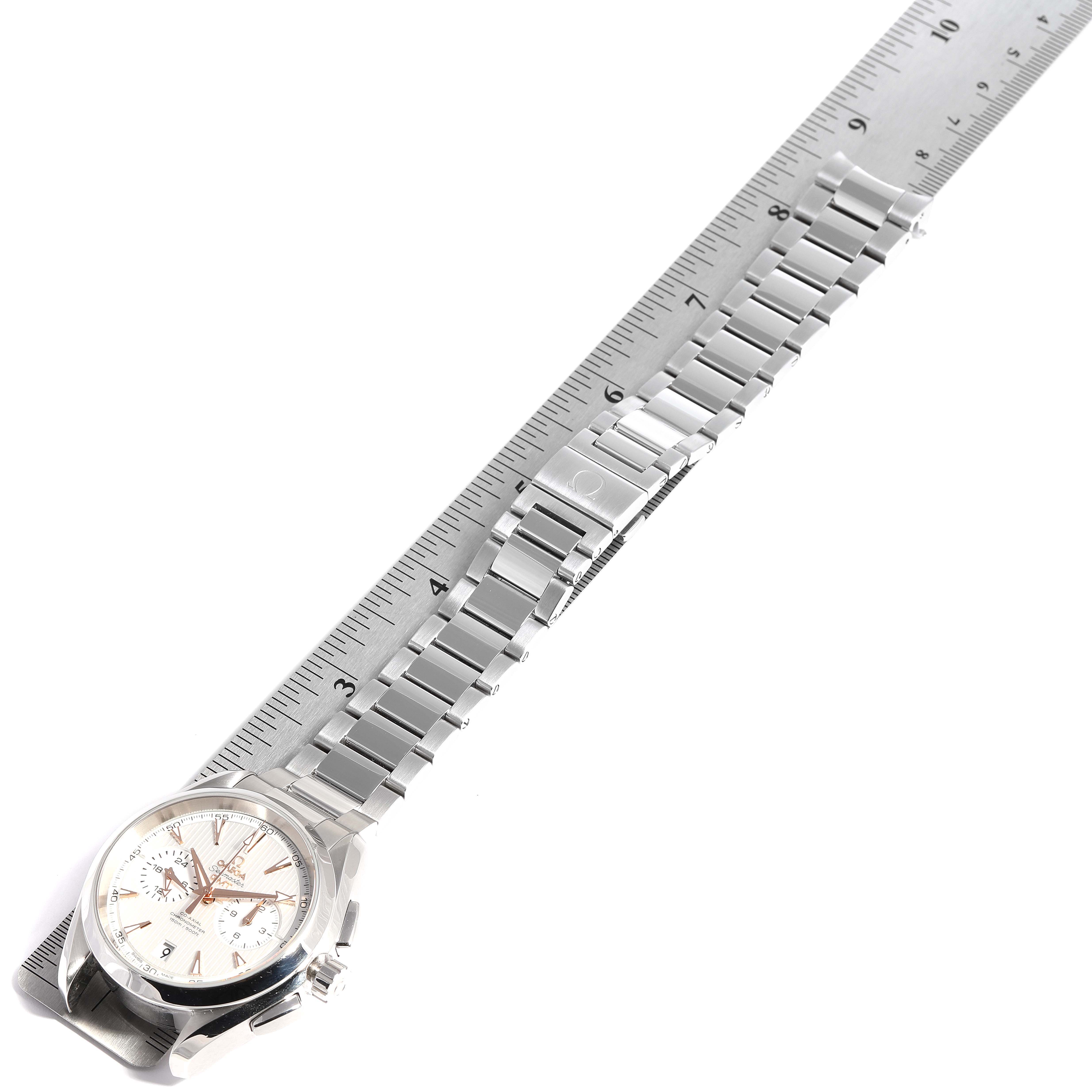 The image shows an Omega Aqua Terra 231.10.43.52.03.001 Men
s Stainless Steel Silver Dial 231.10.43.52.03.001 Men
s Stainless Steel Silver Dial watch placed parallel to a ruler, displaying its face, case, and metal bracelet.