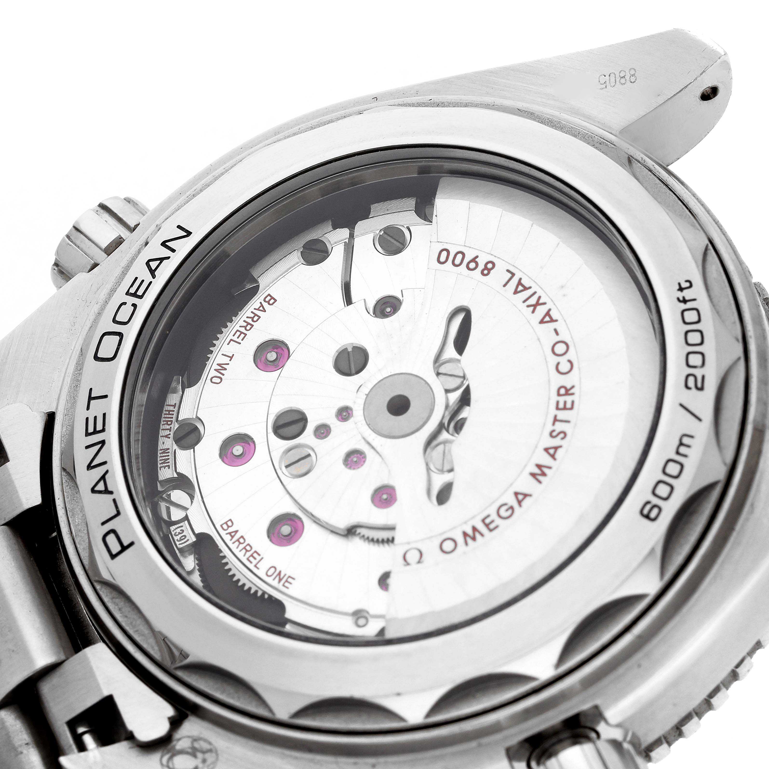 The image shows the back of an Omega Seamaster 215.30.44.21.01.001 Men
s Stainless Steel Black Dial, displaying its exposed movement and inscriptions like "Planet Ocean."