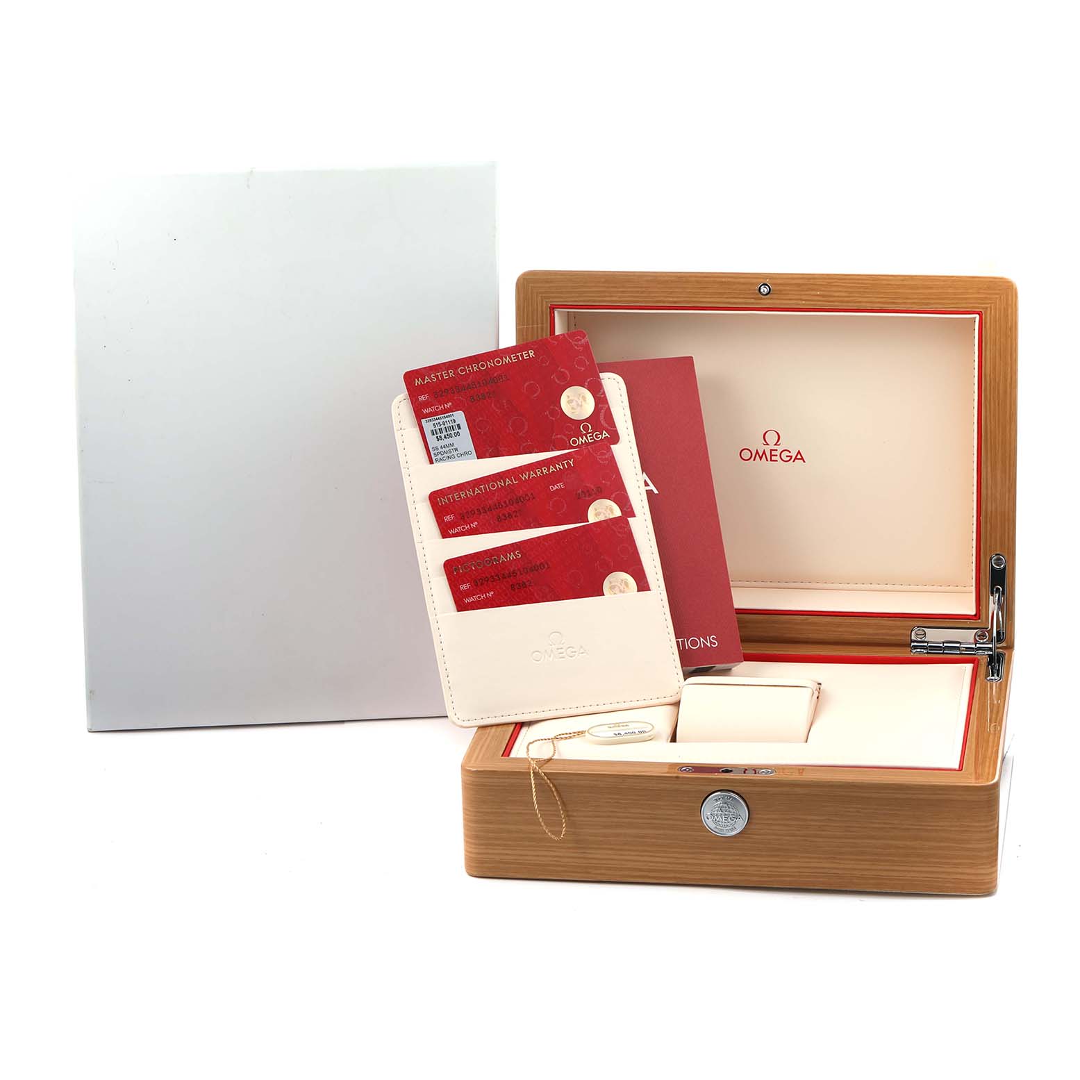 The image shows an Omega Speedmaster 329.33.44.51.04.001 Men
s Stainless Steel Silver Dial watch box with warranty cards and a manual, viewed from the front.