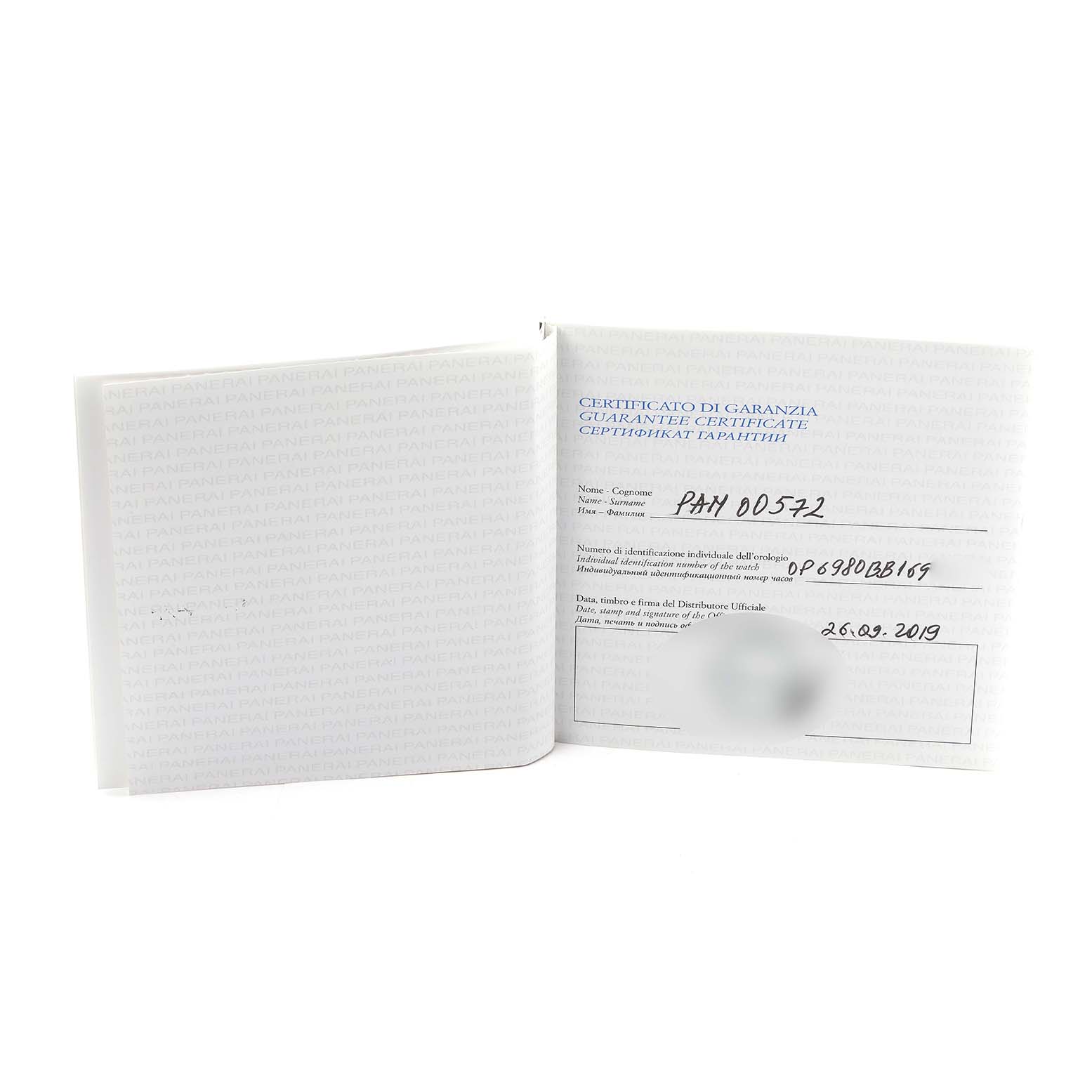 The image shows an open warranty certificate booklet for a Panerai Radiomir PAM00572 Men
s Stainless Steel Black Dial watch.