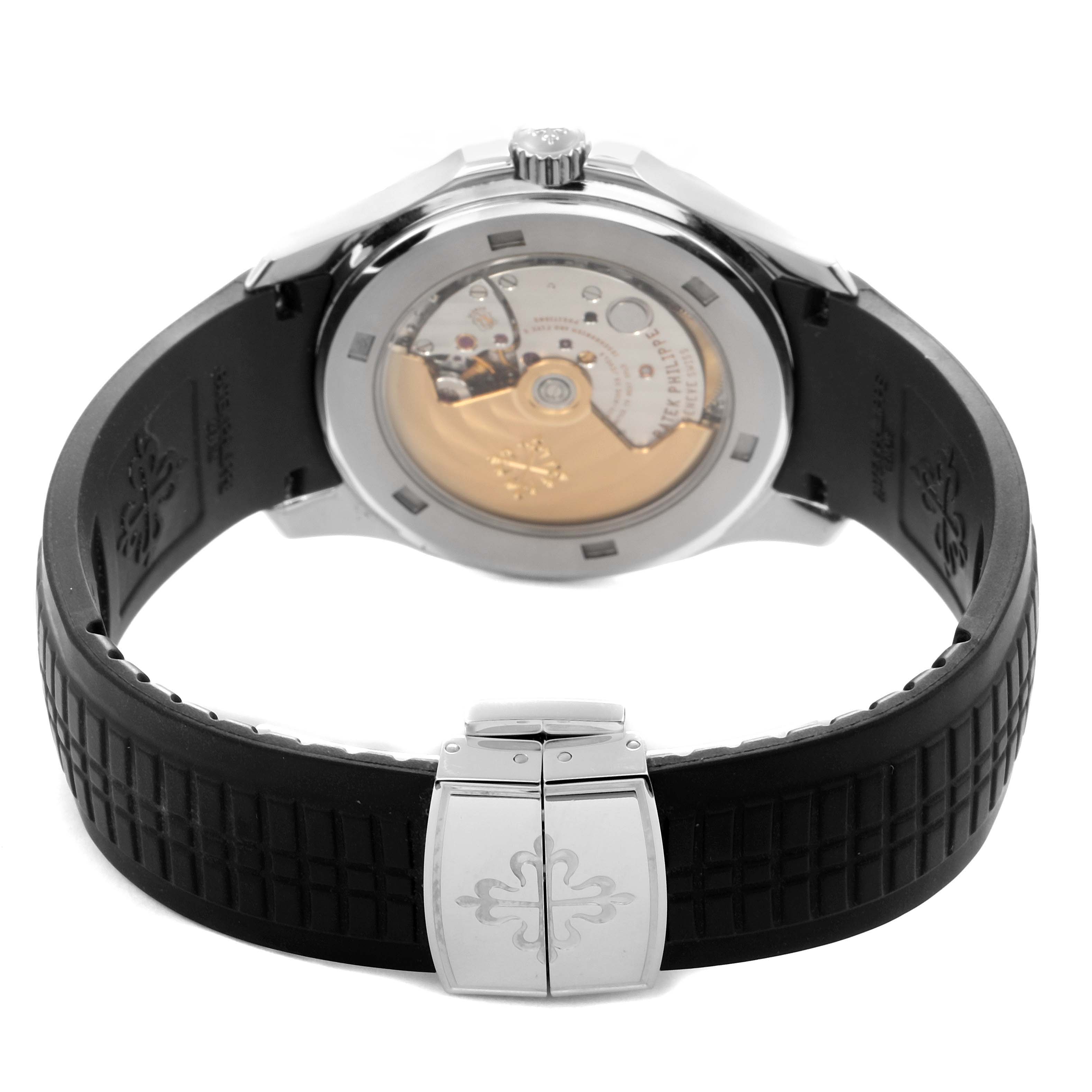 The image shows the back view of a Patek Philippe Aquanaut 5165A Men
s Stainless Steel Grey Dial, highlighting the movement and rubber strap with clasp.