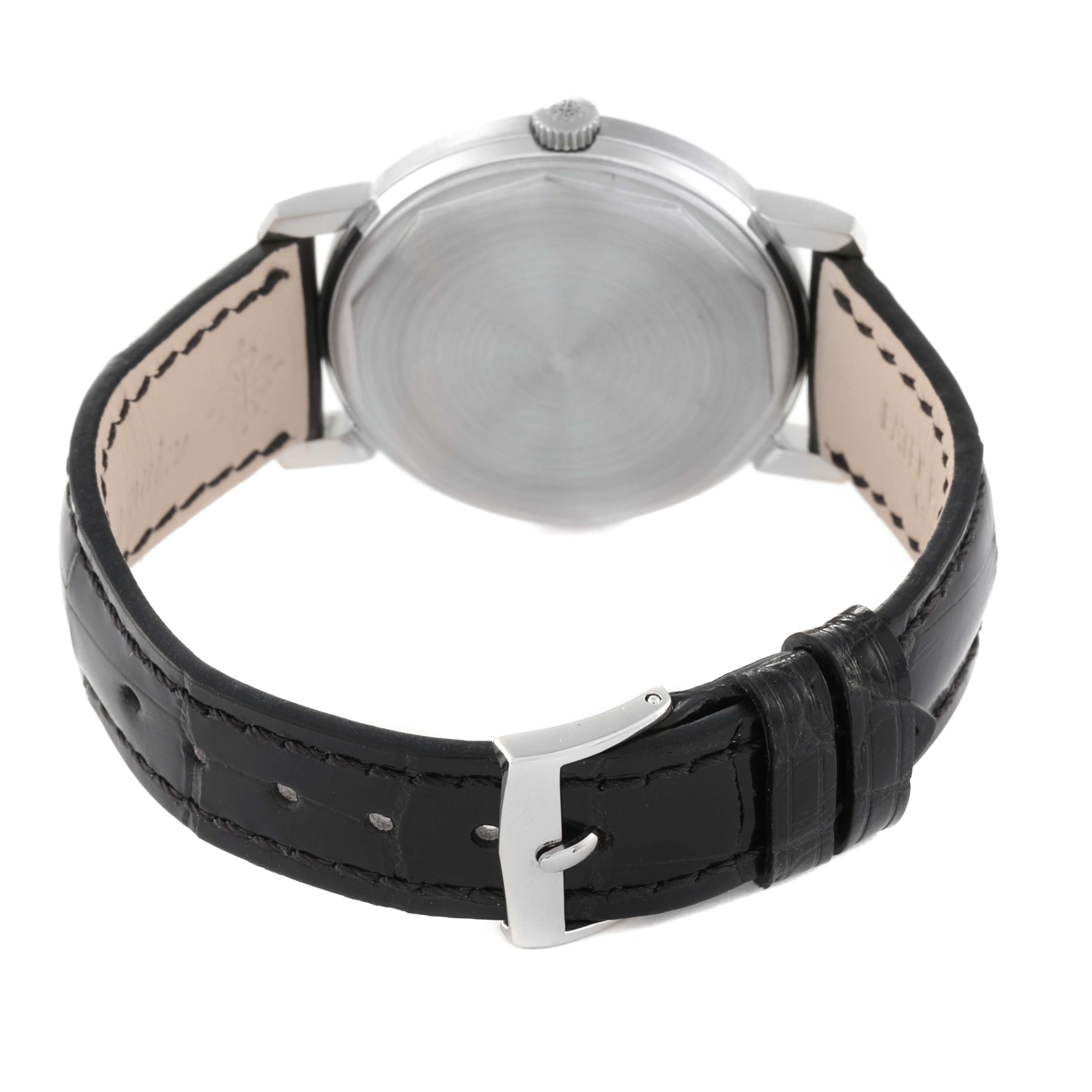 The image shows the back angle of a Vintage Patek Philippe watch, including the case back, crown, and leather strap with buckle.