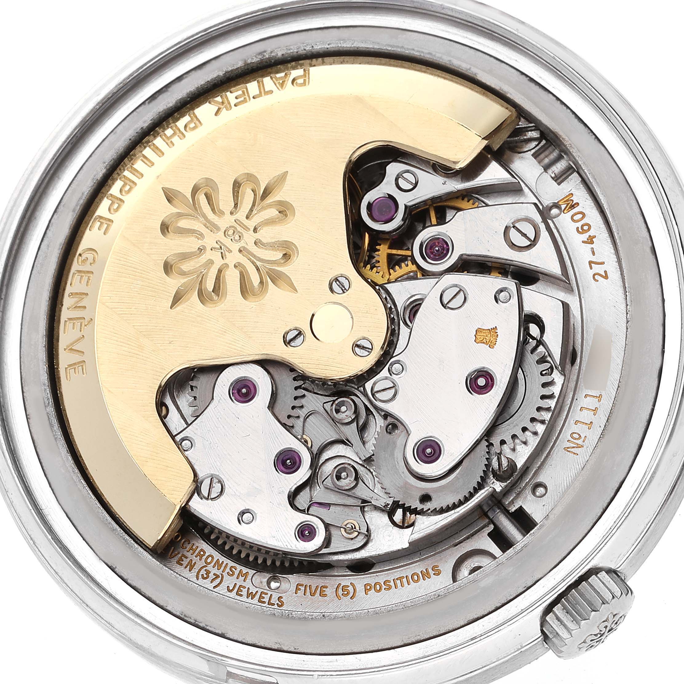 This image shows the intricate internal mechanism of a Vintage Patek Philippe watch from a close-up, rear angle.