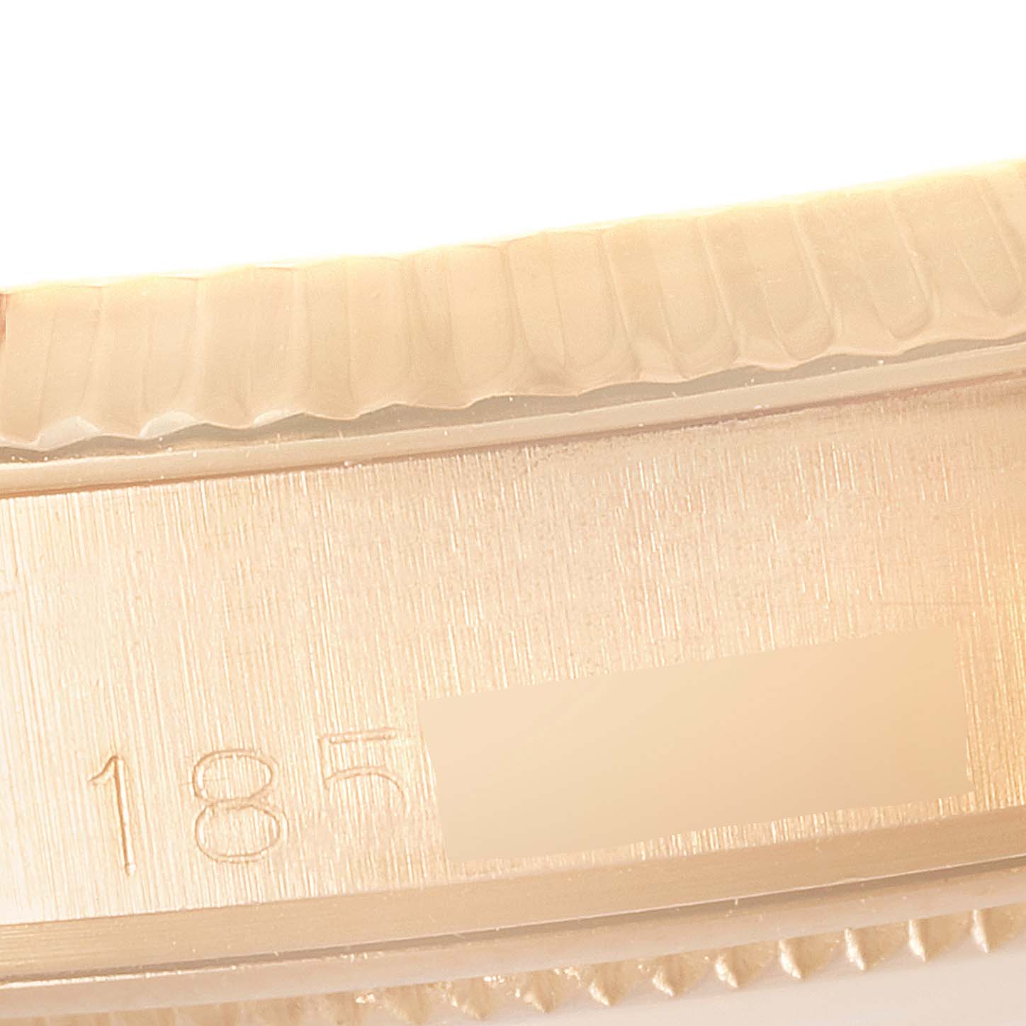 This close-up image shows the serial number and part of the bezel of a Vintage Collection Rolex watch.