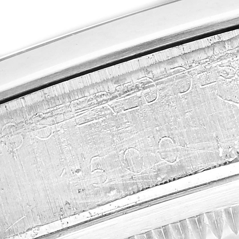 This close-up image shows the engraved serial number and part of the bezel of the Rolex Vintage Collection 1500 Men's Stainless Steel Black Dial 1500 Men's Stainless Steel Black Dial model watch.