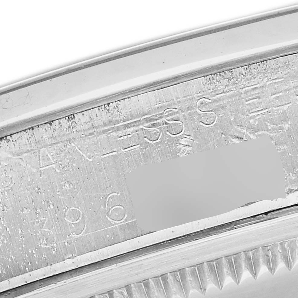 This image shows the engraved serial number and case details on the side of a Vintage Collection Rolex watch.
