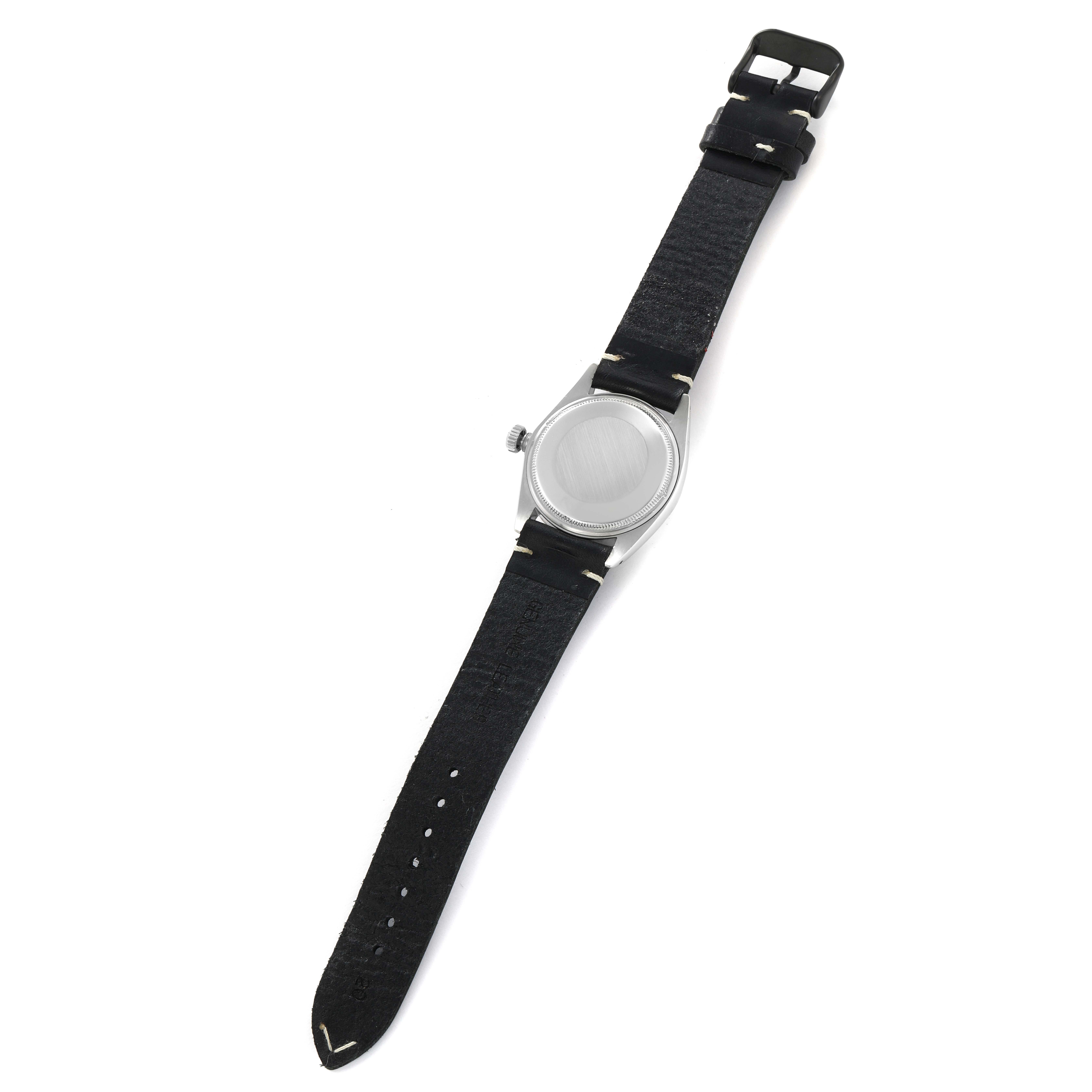 The image shows the back of a Rolex Date 1500 Men
s Stainless Steel Black Dial watch, featuring the case back, crown, and black strap, viewed at an oblique angle.