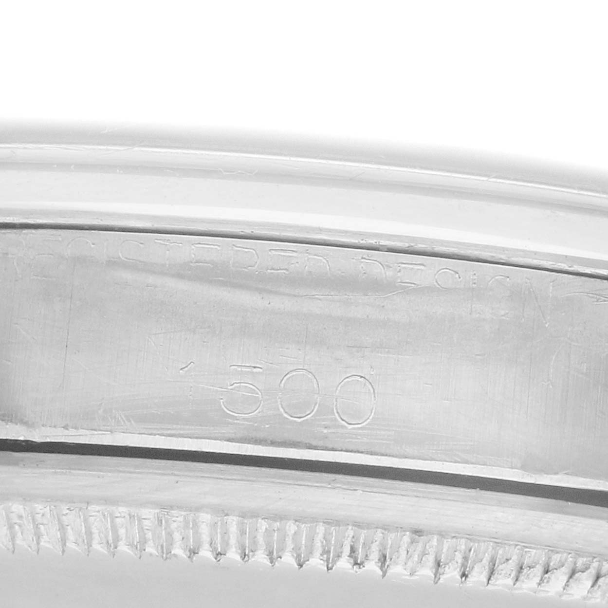 The image shows a close-up of the side view of the bezel and case engraving on a Rolex Date 1500 Men
s Stainless Steel Black Dial model watch.