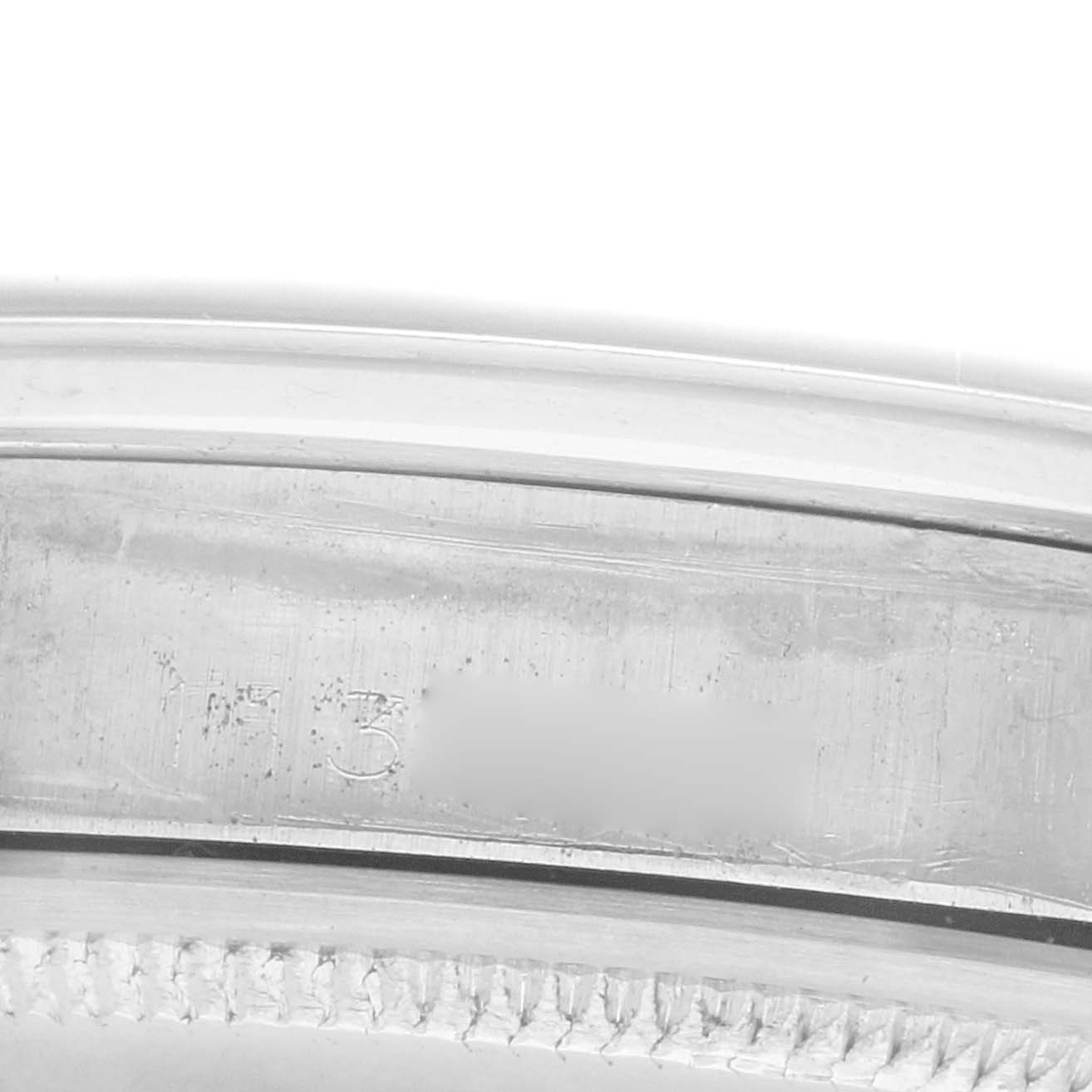 The image shows a close-up of the inner bezel and case edge of a Rolex Date 1500 Men
s Stainless Steel Black Dial watch.