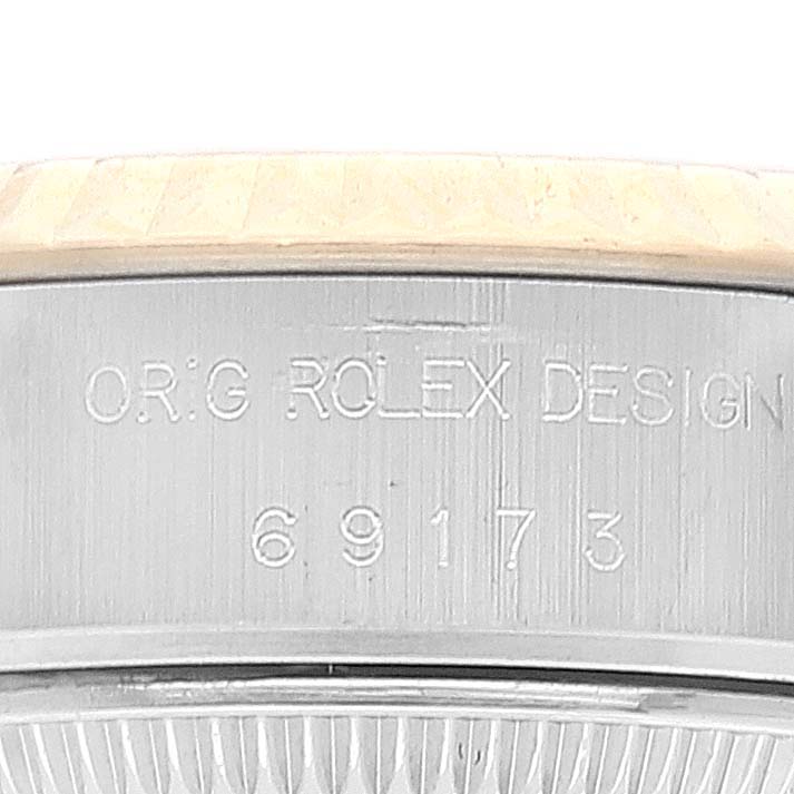 This image shows the case side of a Rolex Datejust 69173 Women's Steel and Gold (two tone) Champagne Dial 69173 Women's Steel and Gold (two tone) Champagne Dial watch, revealing its model number and "O.R.G ROLEX DESIGN" engraving.