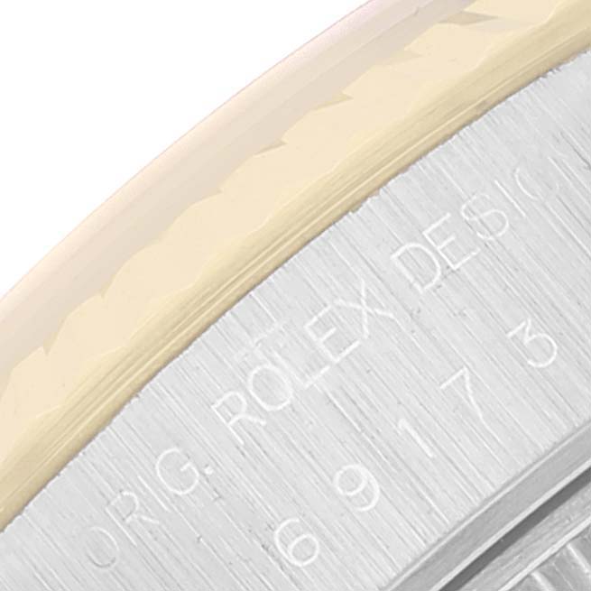 This image shows a close-up of the side engraving and part of the bezel on a Rolex Datejust 69173 Women's Steel and Gold (two tone) Champagne Dial 69173 Women's Steel and Gold (two tone) Champagne Dial watch.