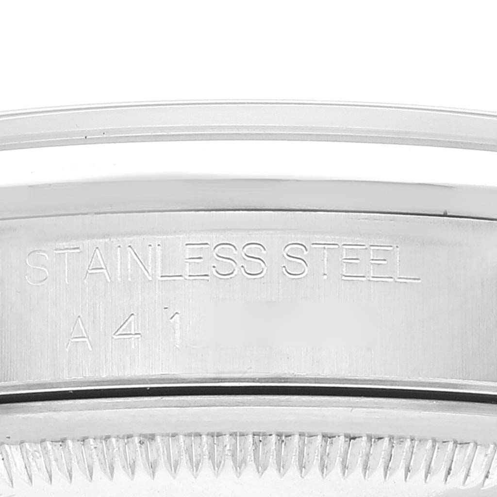 The image shows a close-up of the stainless steel casing of a Rolex Datejust 16200 Men's Stainless Steel Grey Dial 16200 Men's Stainless Steel Grey Dial watch with "STAINLESS STEEL" engraved on it. 