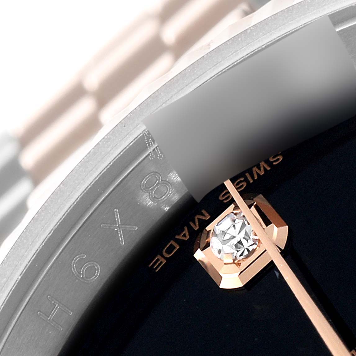 Close-up of the Rolex Datejust 116231 Men's Steel and Gold (two tone) Black Dial 116231 Men's Steel and Gold (two tone) Black Dial watch, showing a diamond hour marker and partial bezel.