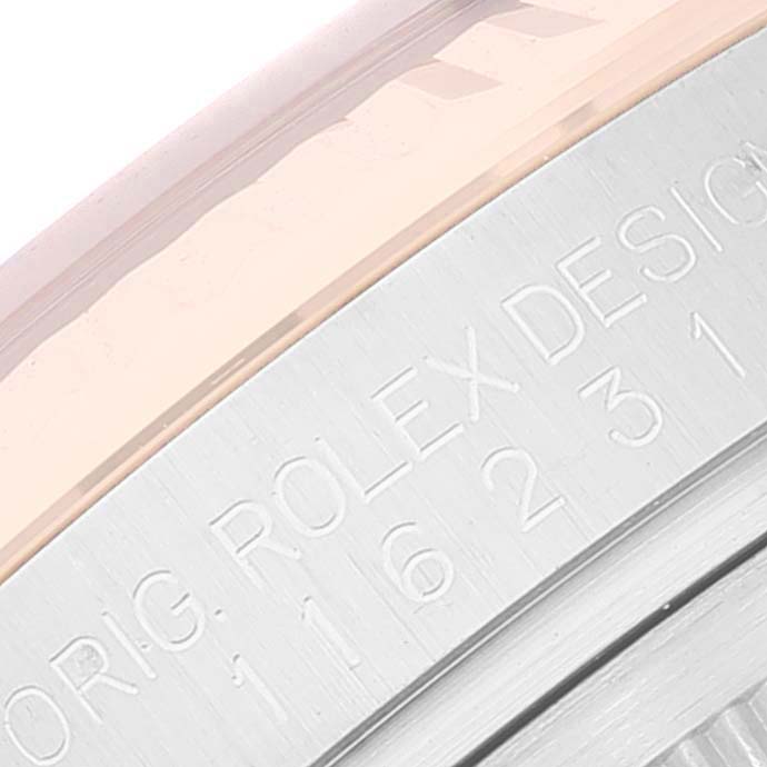 The image shows a close-up of the side engraving and bezel of a Rolex Datejust 116231 Men's Steel and Gold (two tone) Black Dial 116231 Men's Steel and Gold (two tone) Black Dial watch.