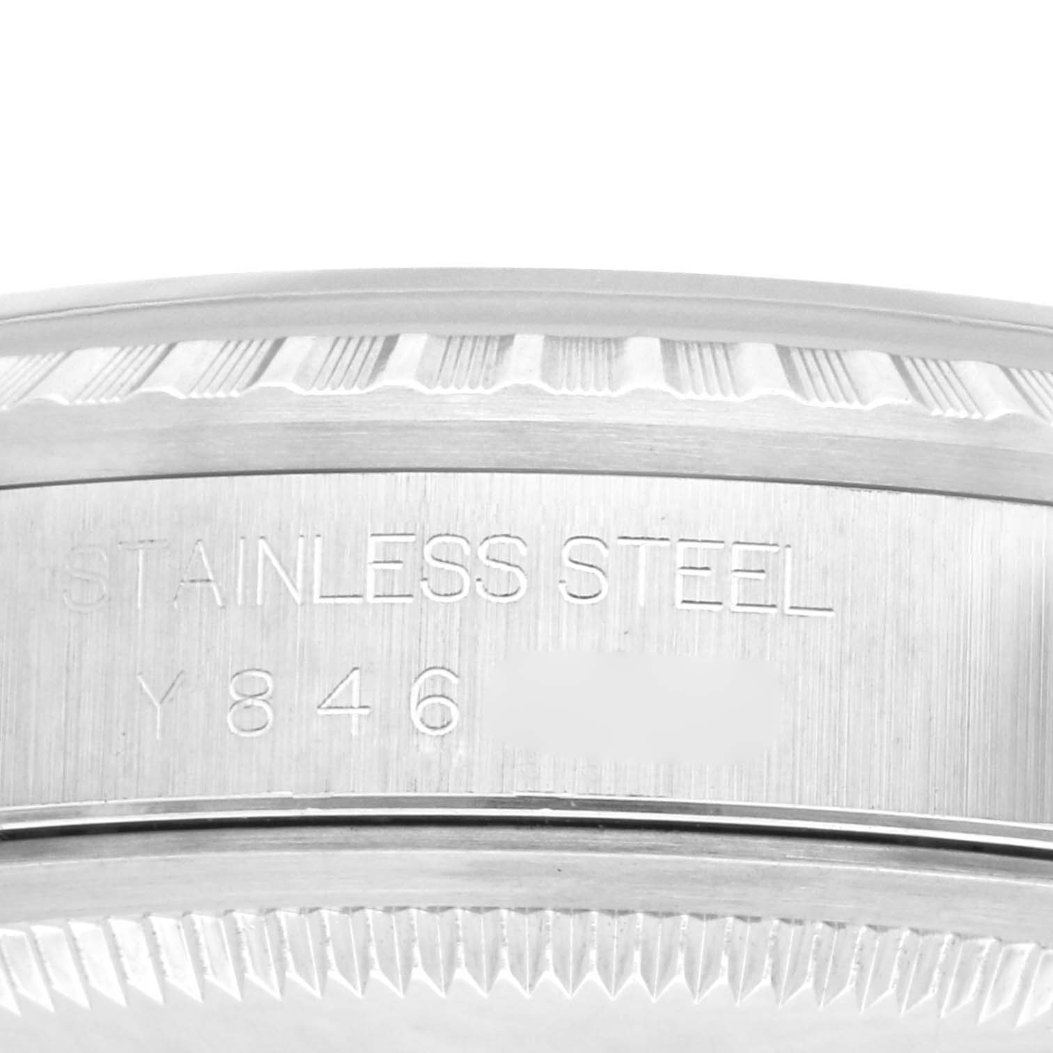 This image shows a close-up of the stainless steel case side of a Rolex Datejust 16220 Men's Stainless Steel White Dial 16220 Men's Stainless Steel White Dial watch, including part of the bezel and a serial number.
