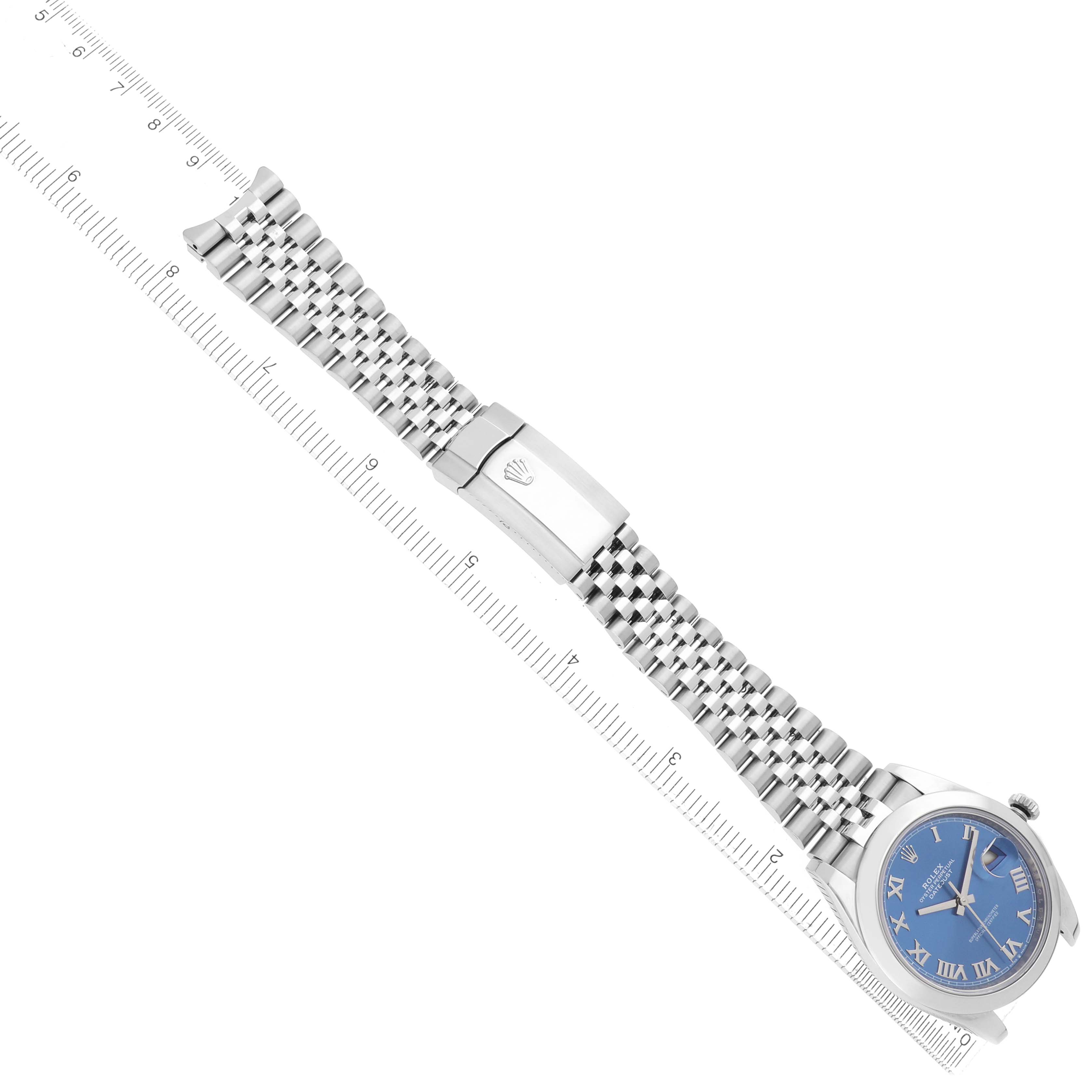 The Rolex Datejust 41 126300 Men
s Stainless Steel Blue Dial is shown from a top view, highlighting the bracelet, clasp, and the watch face at an angle, alongside a ruler.