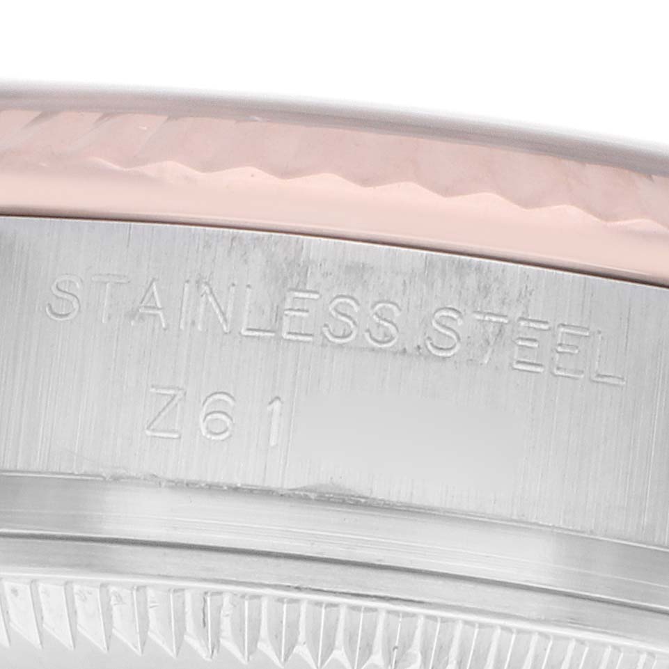 The image shows a close-up of the stainless steel case back and bezel edge of a Rolex Datejust 179171 Women
s Steel and Gold (two tone) Pink Dial watch.