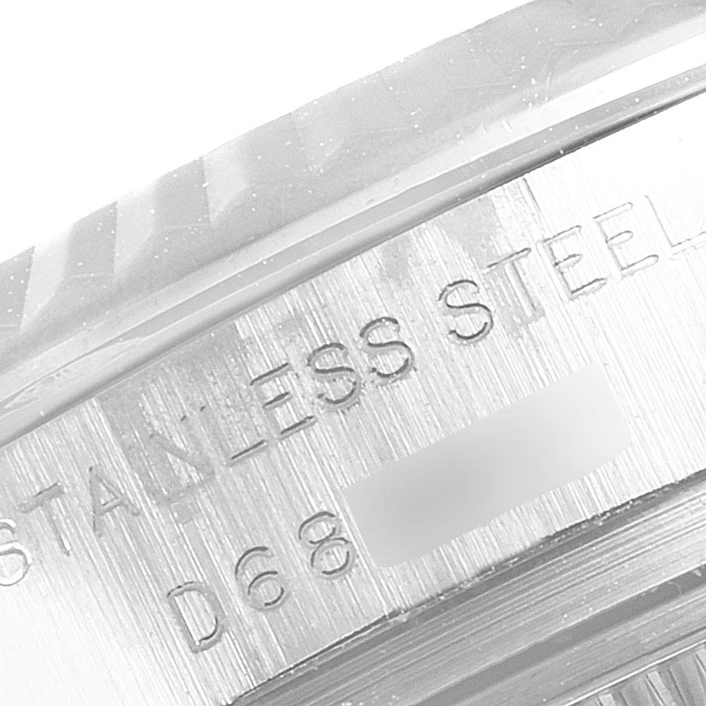 This image shows a close-up of the engraved text on the side of a Rolex Datejust 179174 Women's Stainless Steel Black Dial 179174 Women's Stainless Steel Black Dial watch, specifically indicating "STAINLESS STEEL" and part of a reference number.